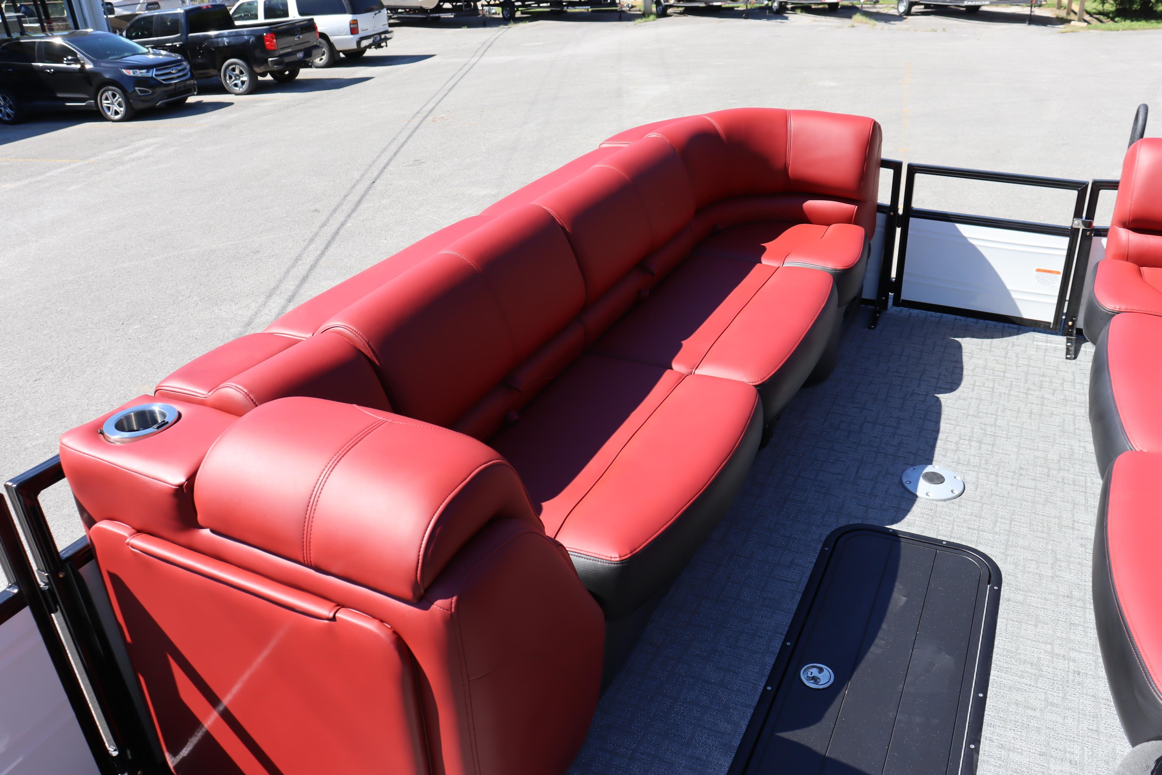 Luxurious red seating on 2026 Regency 250 DL pontoon boat, featuring modern design and comfort.
