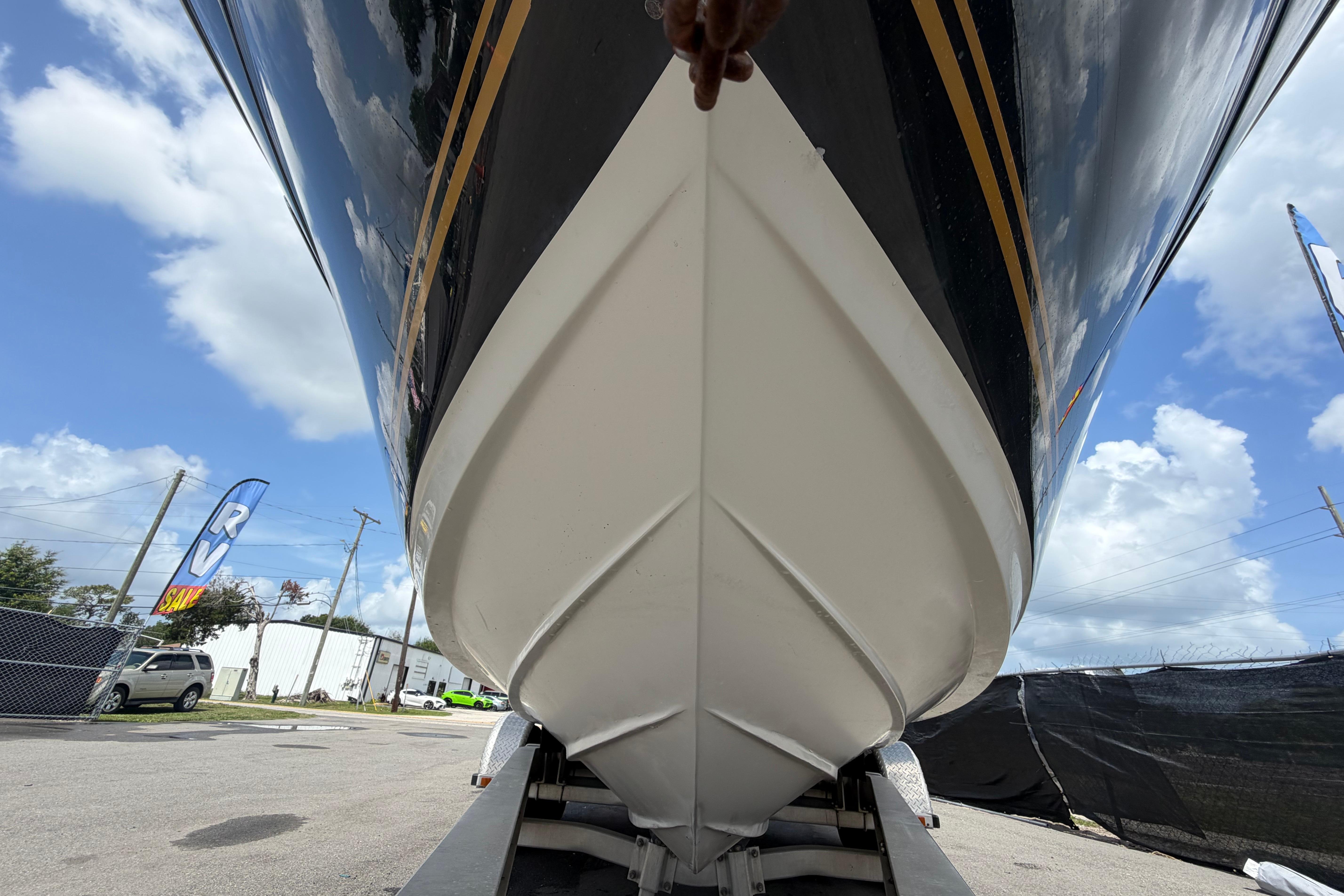2006 Sea Ray 250 Amberjack boat hull on trailer under blue sky.