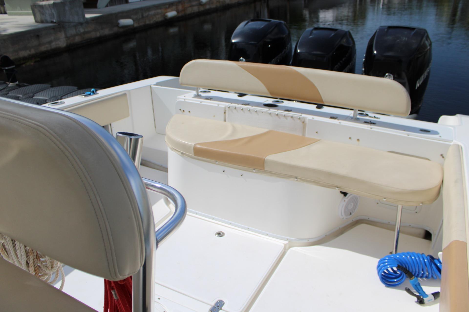 2007 Fountain 34 Center Console boat interior with seating and triple outboard motors.
