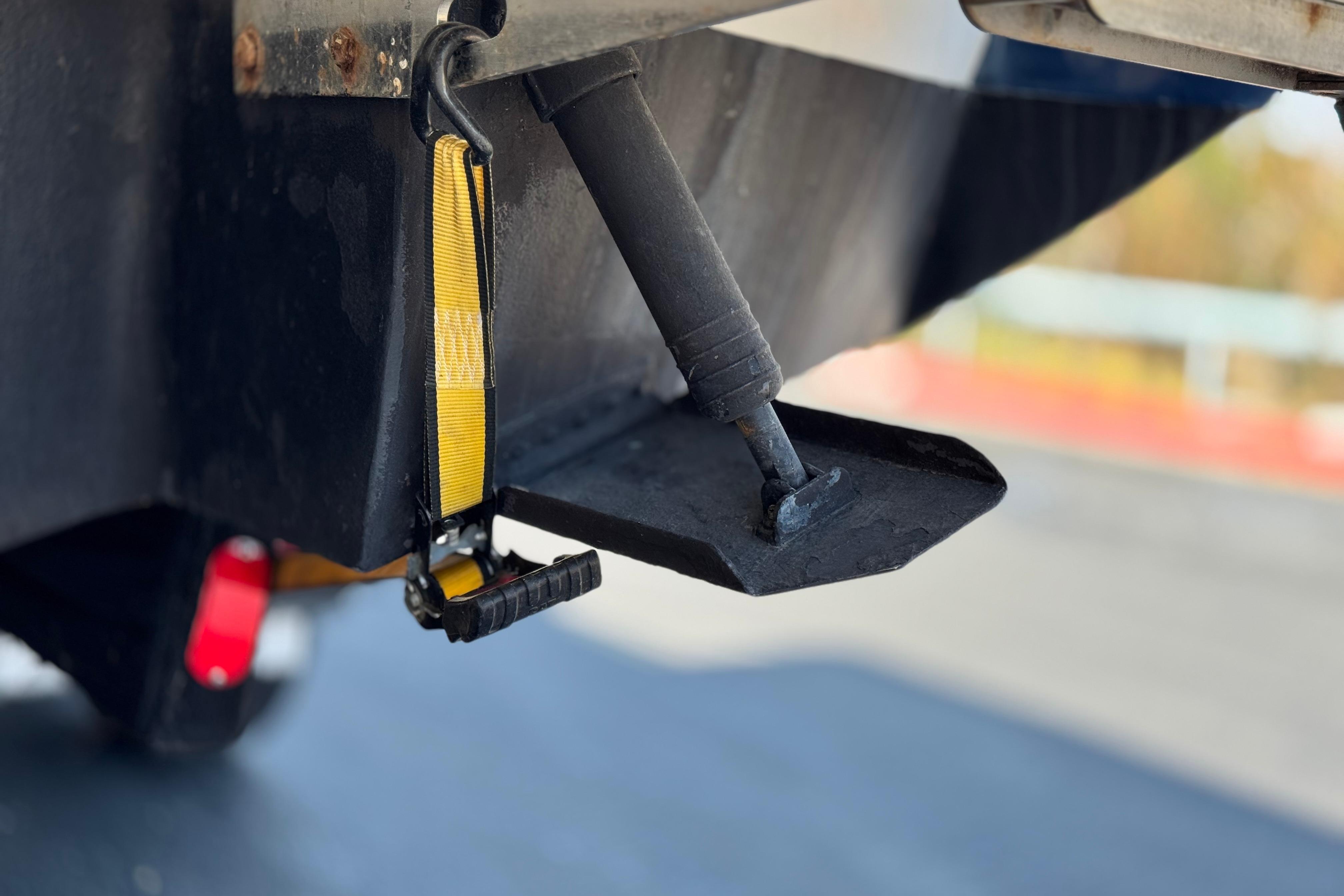 Close-up of a 2008 Cobalt 262 boat's trim tab and strap mechanism.