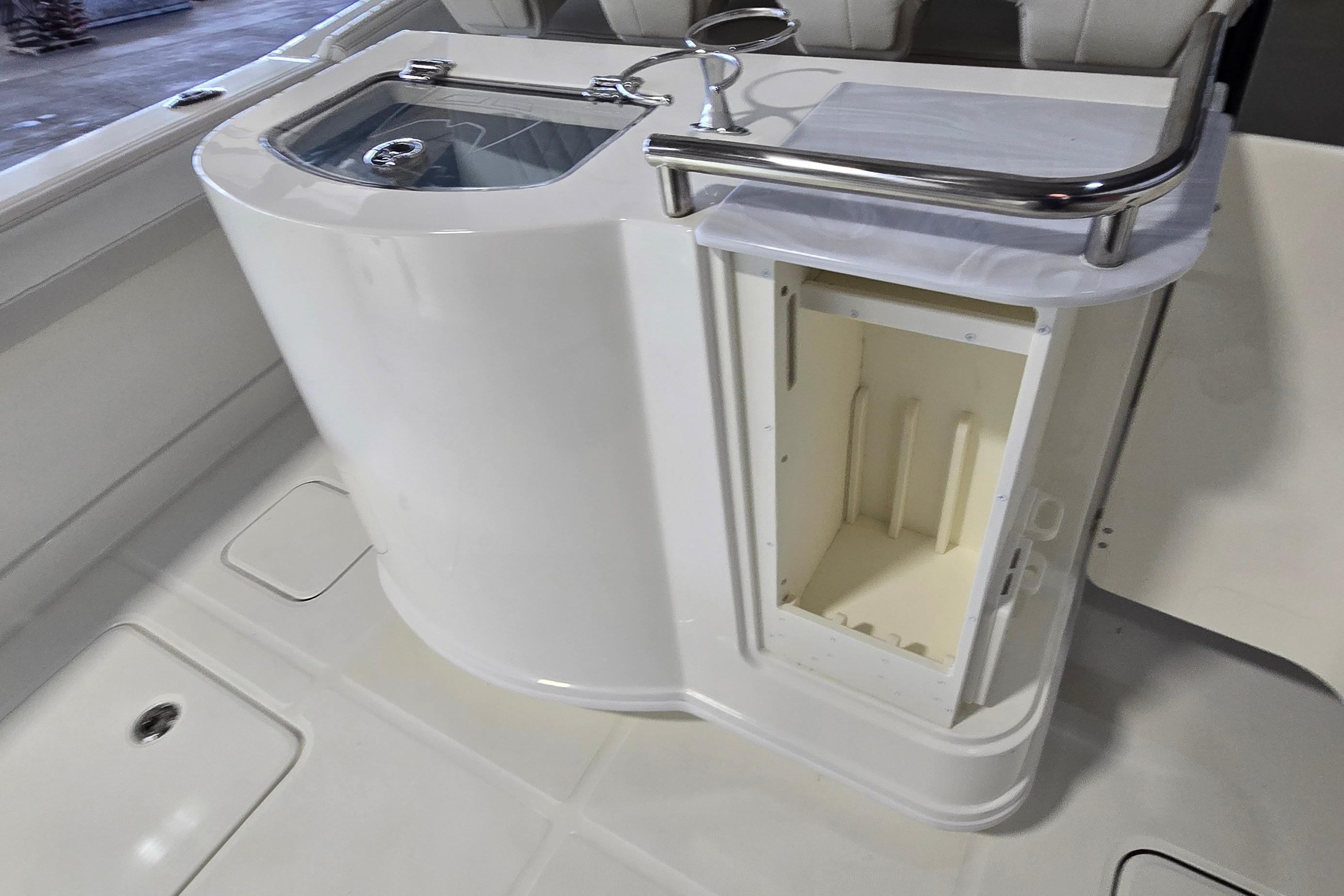 2024 WorldCat 280 CC-X boat interior with storage compartment and sink.