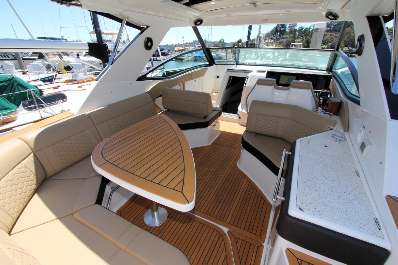 2021 Sea Ray Sundancer 320 Outboard interior with luxurious seating and elegant wood finishes.