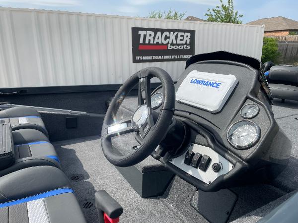 2025 Ranger RT188P boat dashboard with Lowrance display and Tracker Boats container in background.