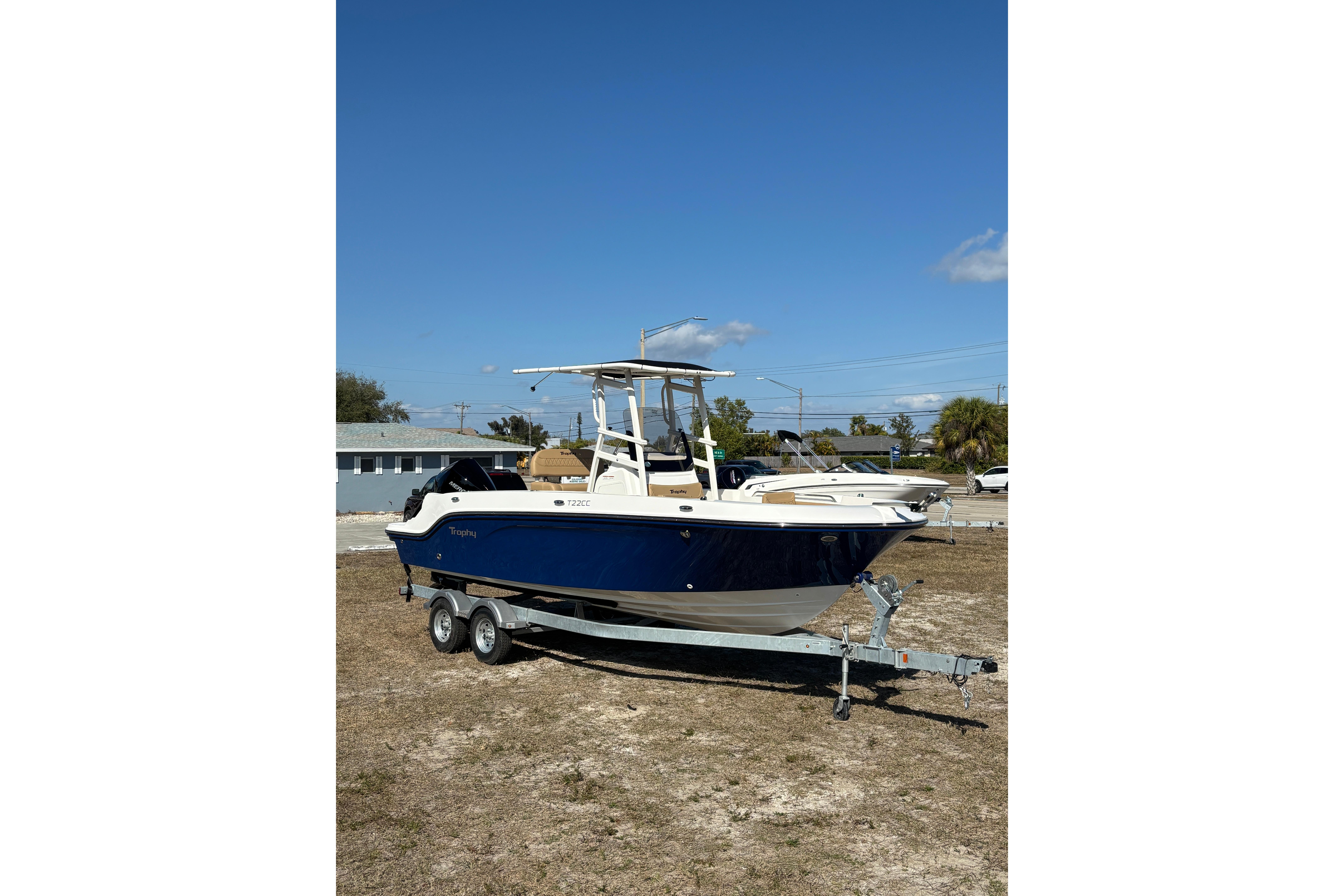 2026 Bayliner Trophy T22CC boat on trailer under clear blue sky.