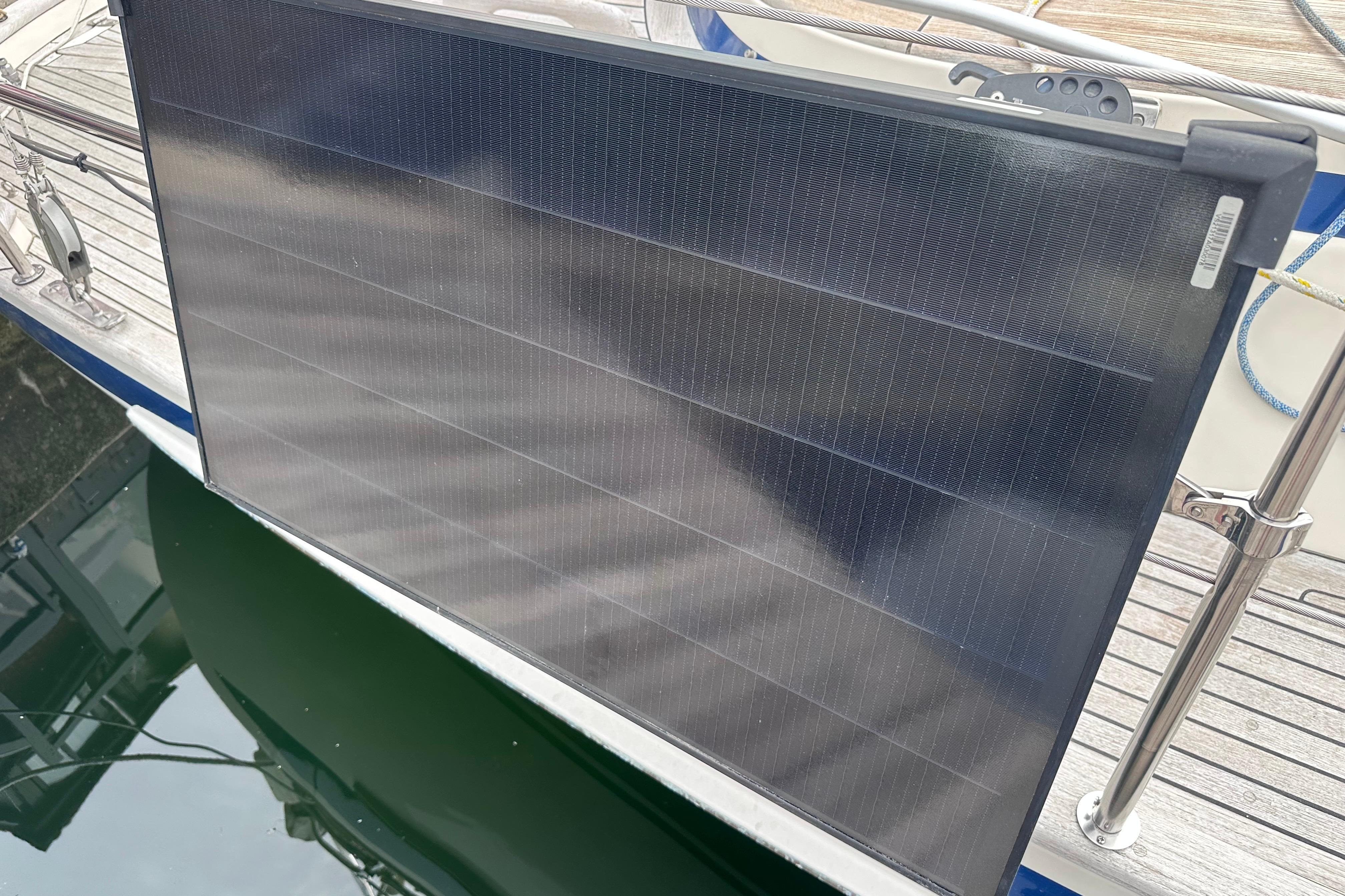 Solar panel on a 1999 Hallberg-Rassy 39 yacht, docked by the water.