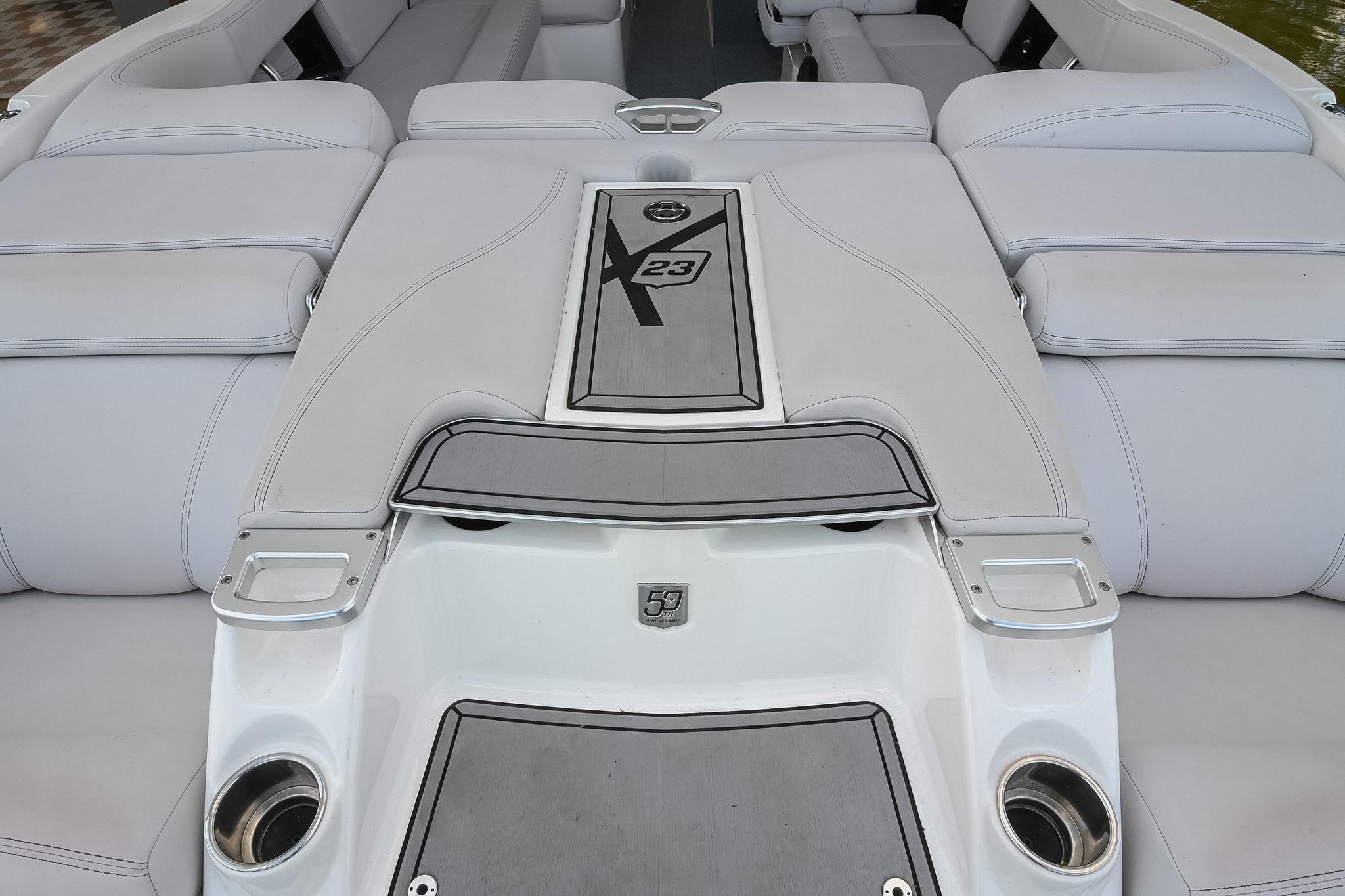 2018 MasterCraft X23 boat interior with cushioned seating and sleek design.