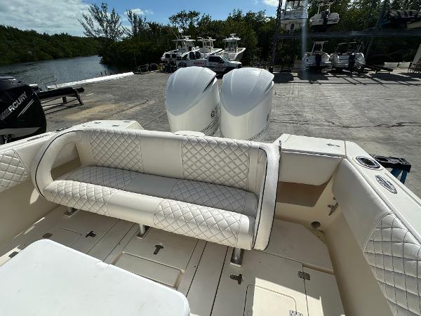 2005 Intrepid 323 boat with white quilted seating and dual outboard motors.