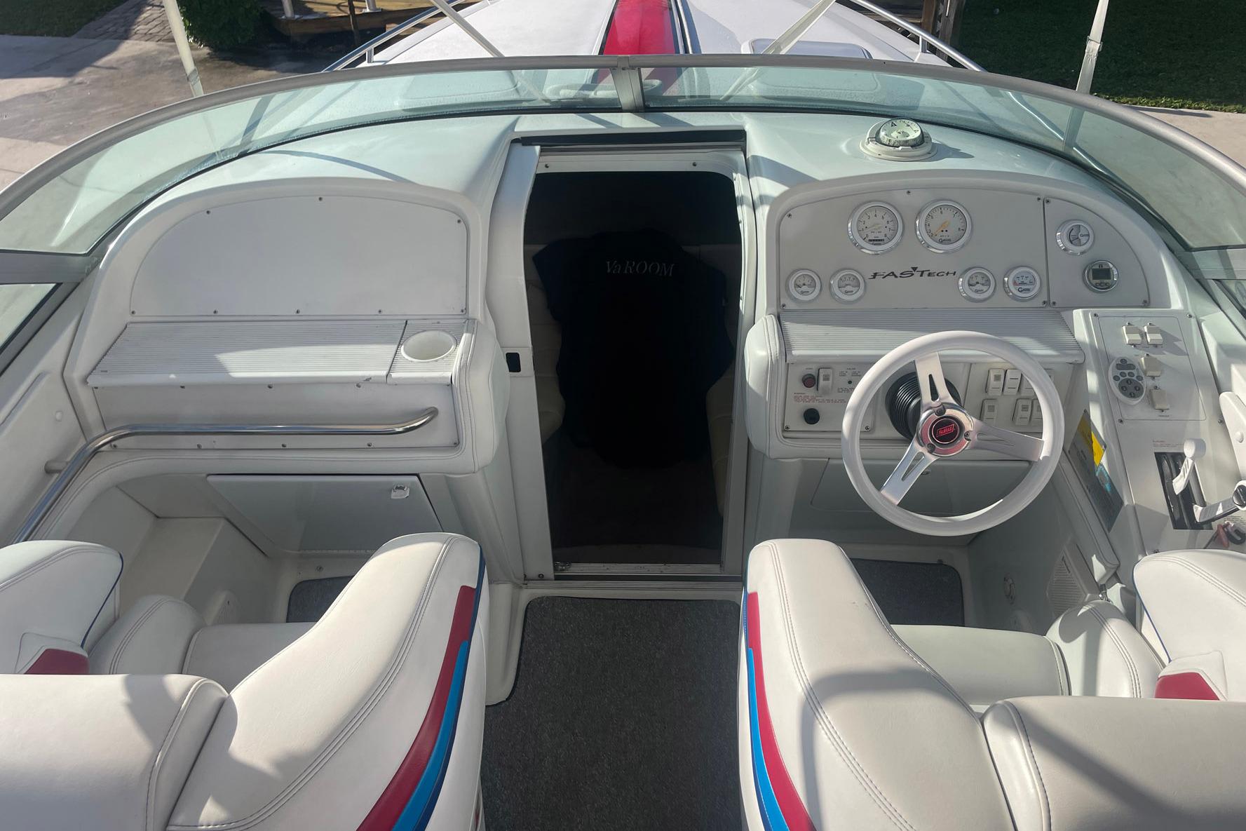 2001 Formula 271 FASTech boat cockpit with white seating and control panel.