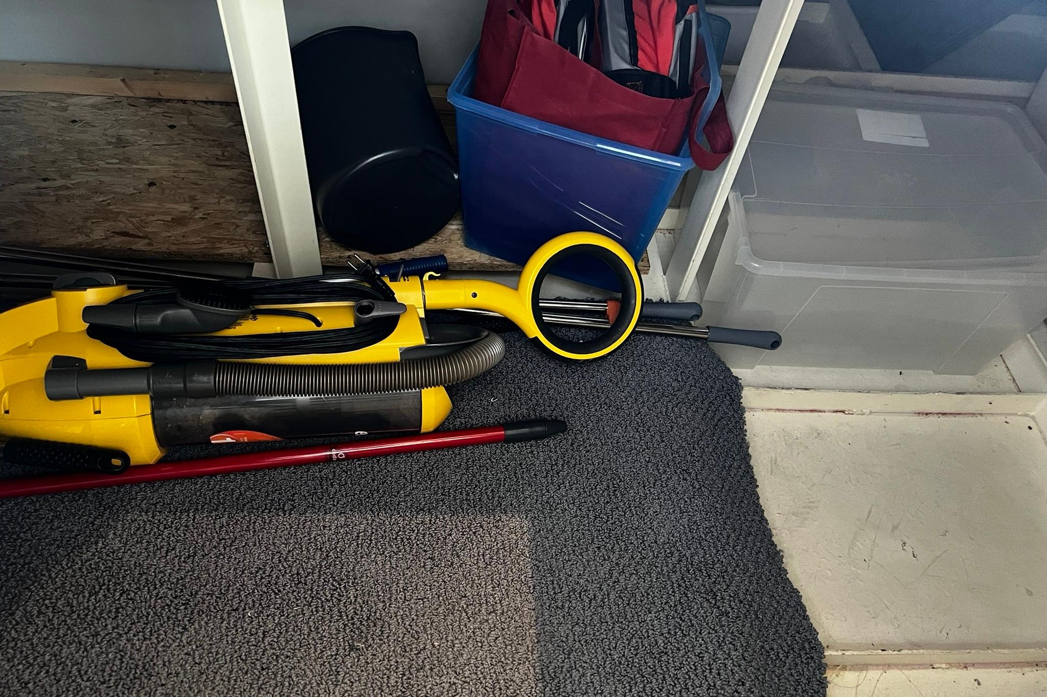 Storage area on Skipperliner 480 Flybridge 2010 with cleaning equipment and containers.