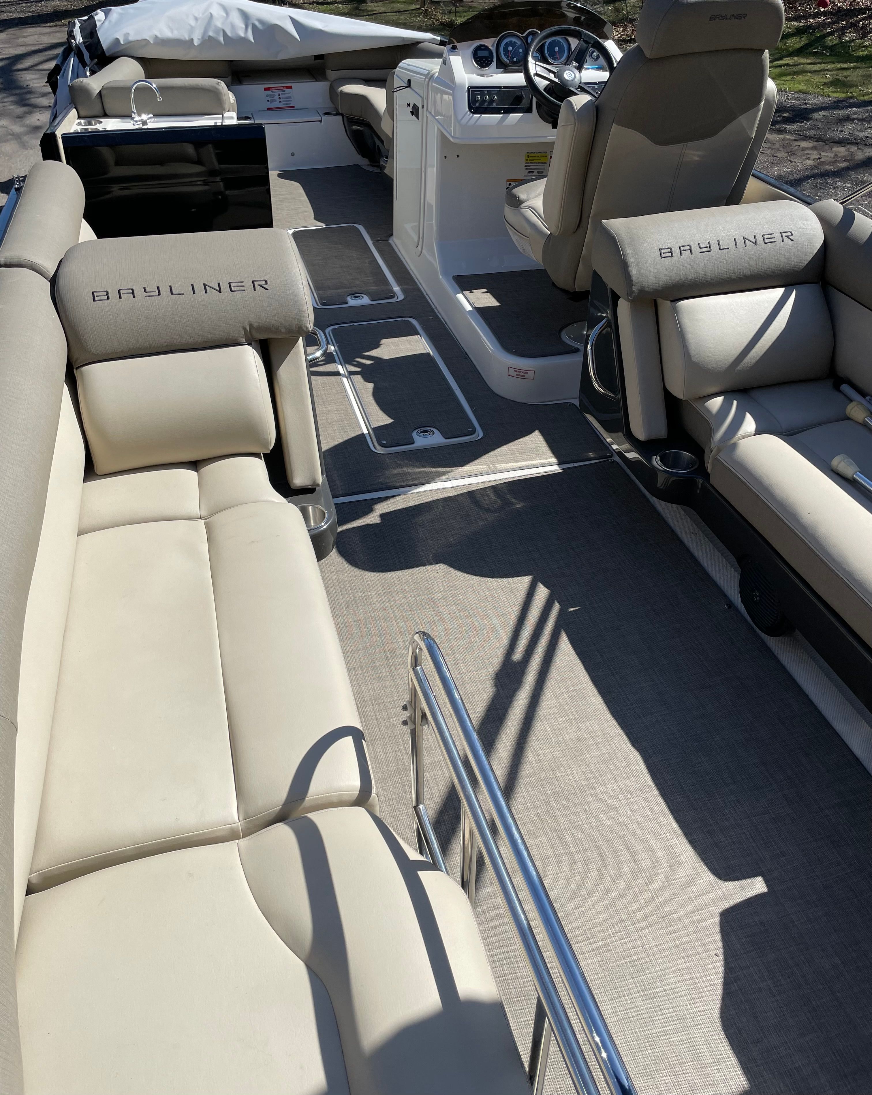 The image shows the interior of a 2016 Bayliner Element XR7 boat with beige seating.