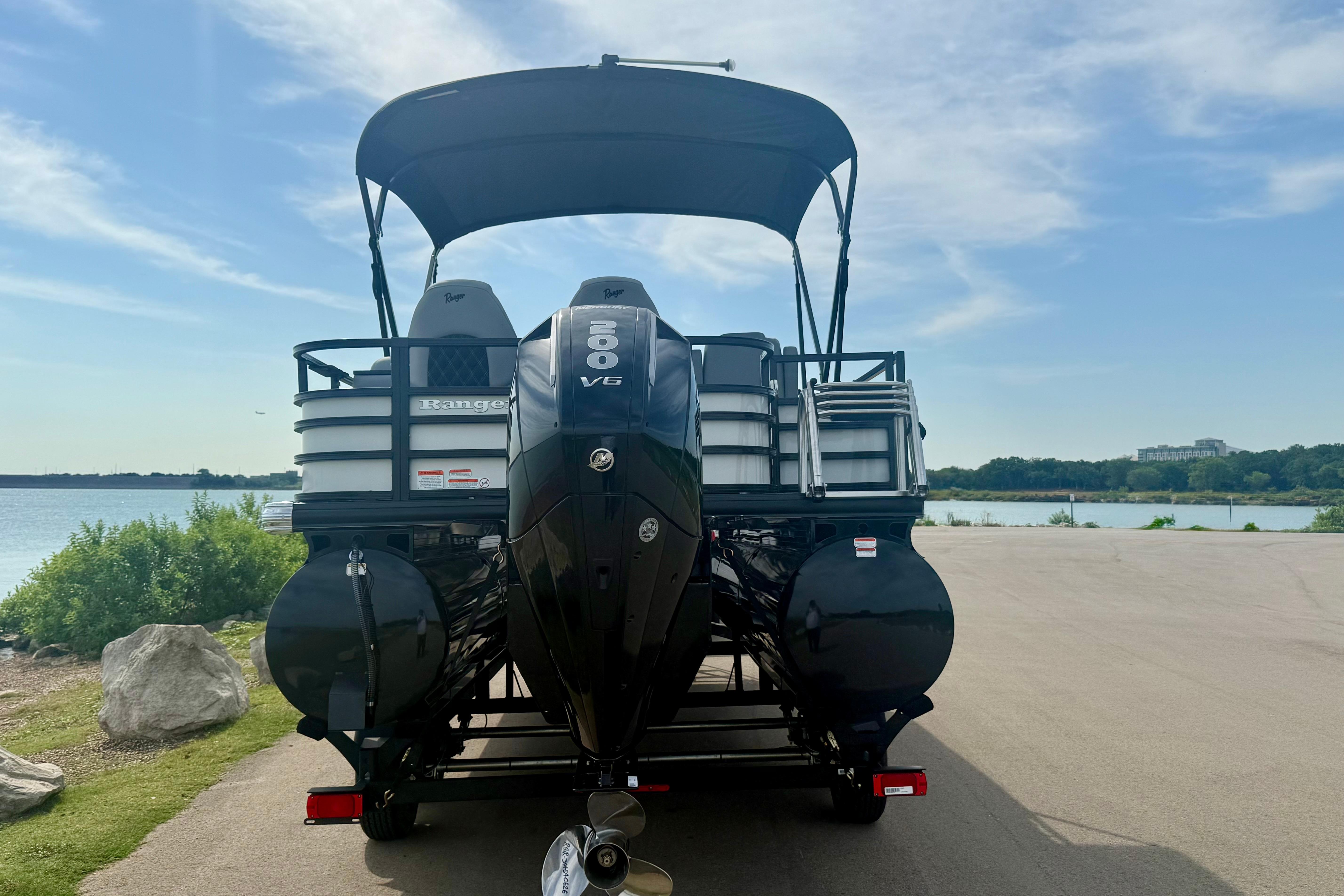 2026 Ranger 223FC pontoon boat with V6 engine by a scenic lake.