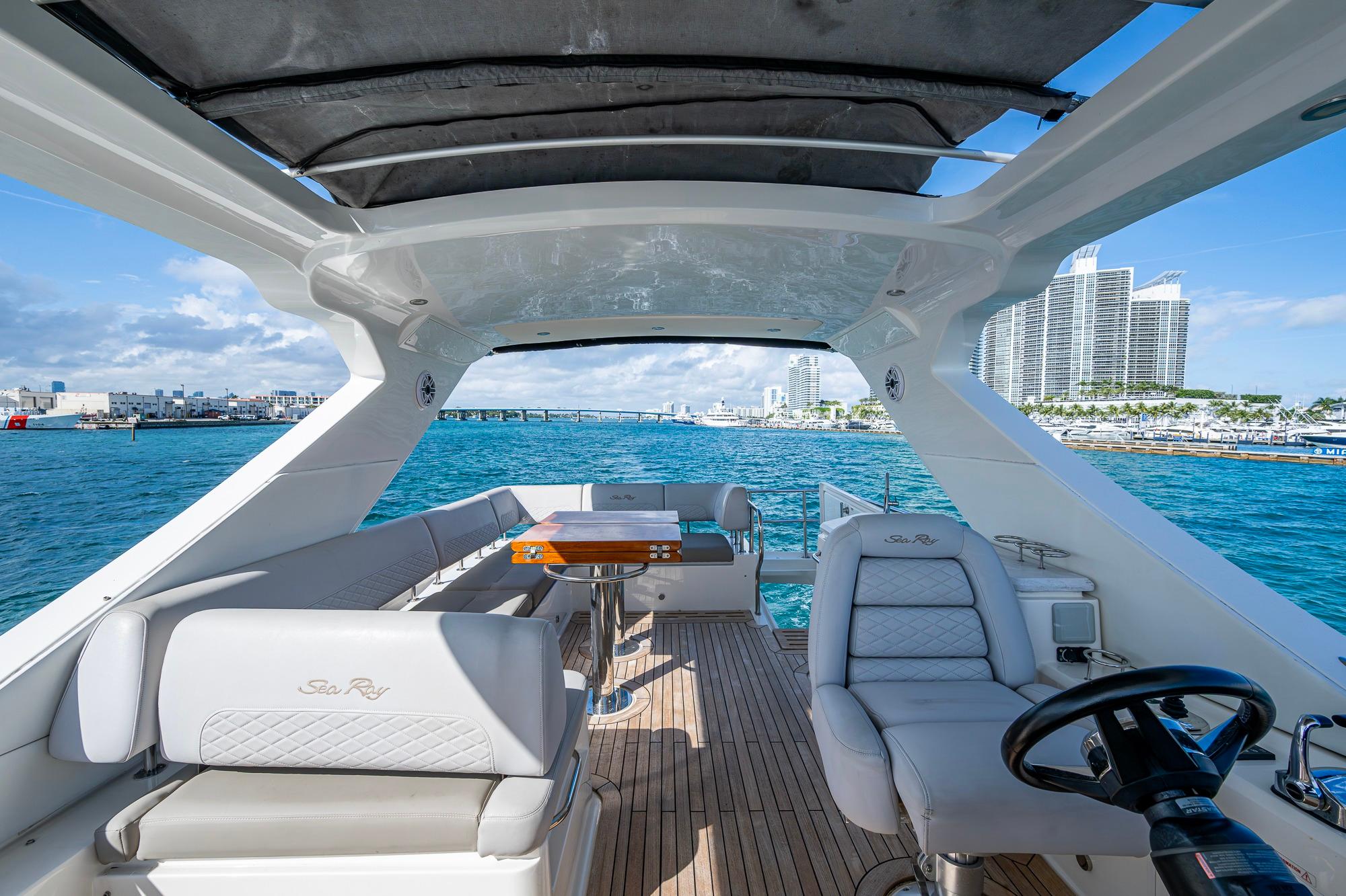 Luxurious 2018 Sea Ray L550 Fly yacht interior with ocean view and modern seating.