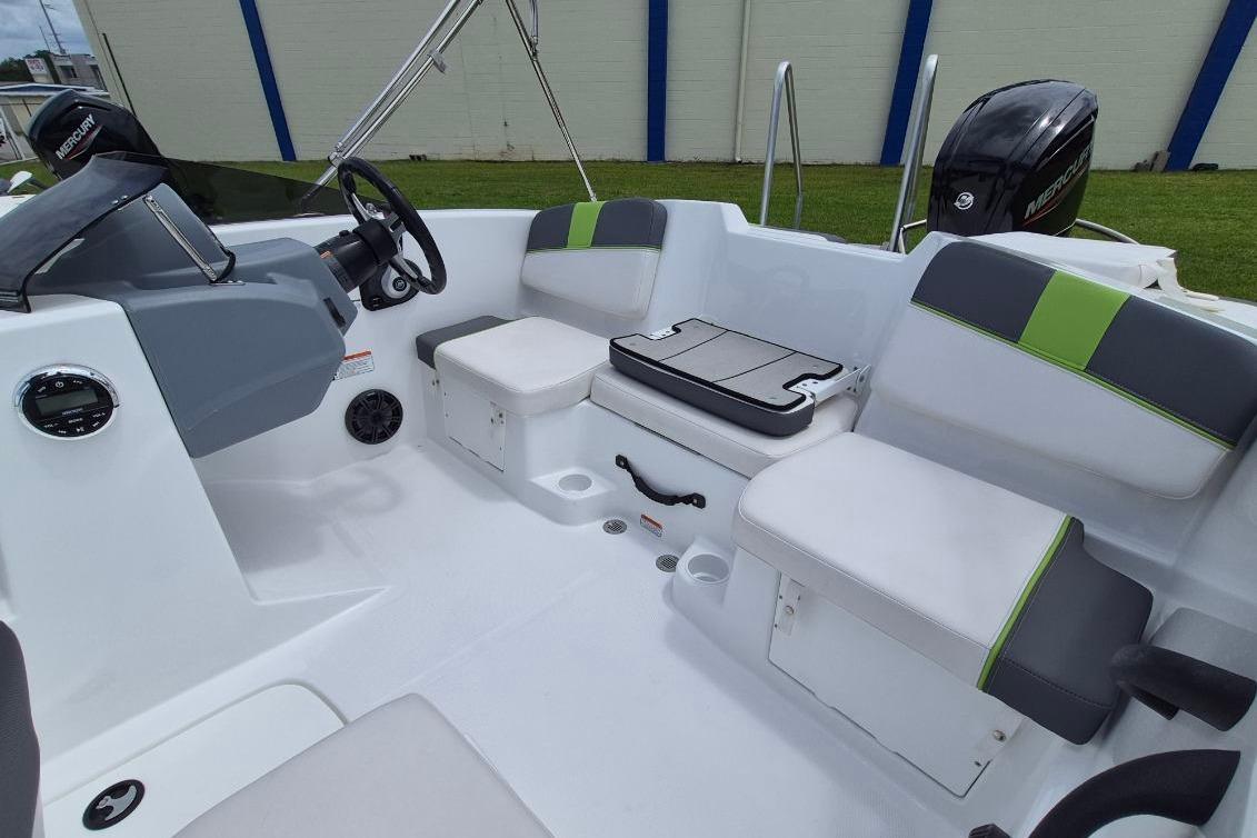 2021 Tahoe T16 boat interior with seating, steering console, and Mercury engine.