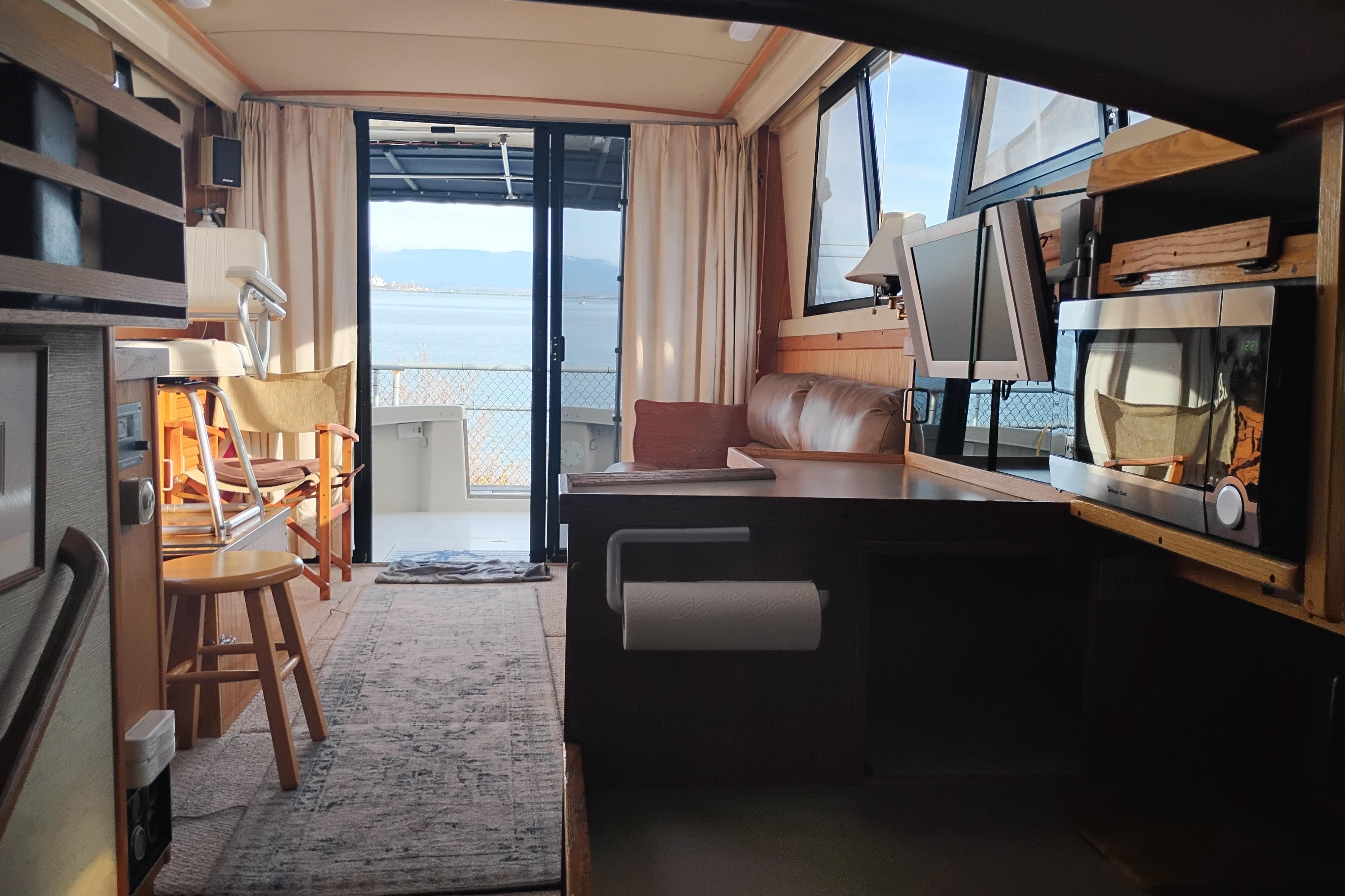 Interior of a 1985 Mainship 34 Mk III yacht with cozy seating and ocean view.