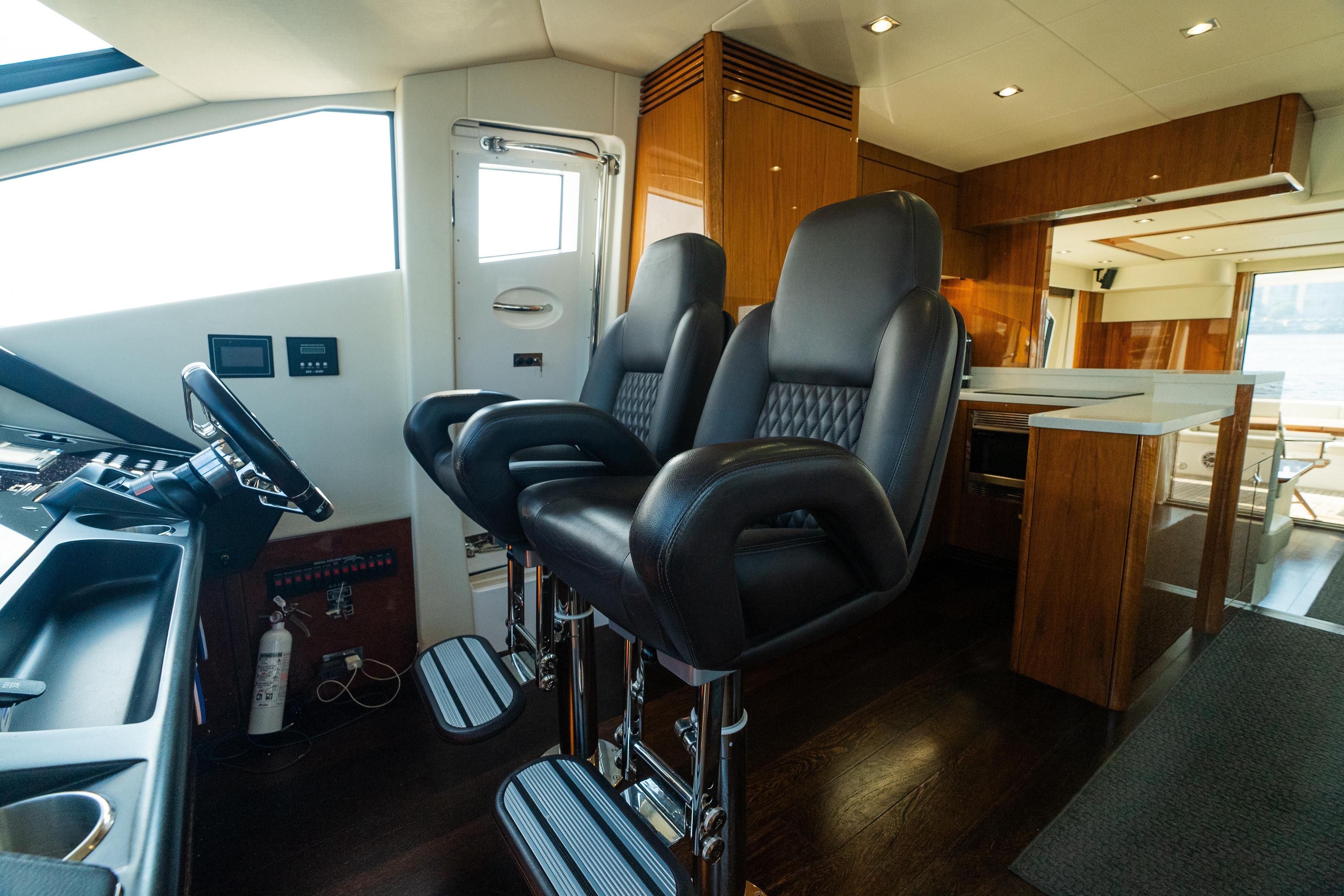 Luxurious interior of 2016 Sunseeker Manhattan 65 yacht with leather seating and modern helm.