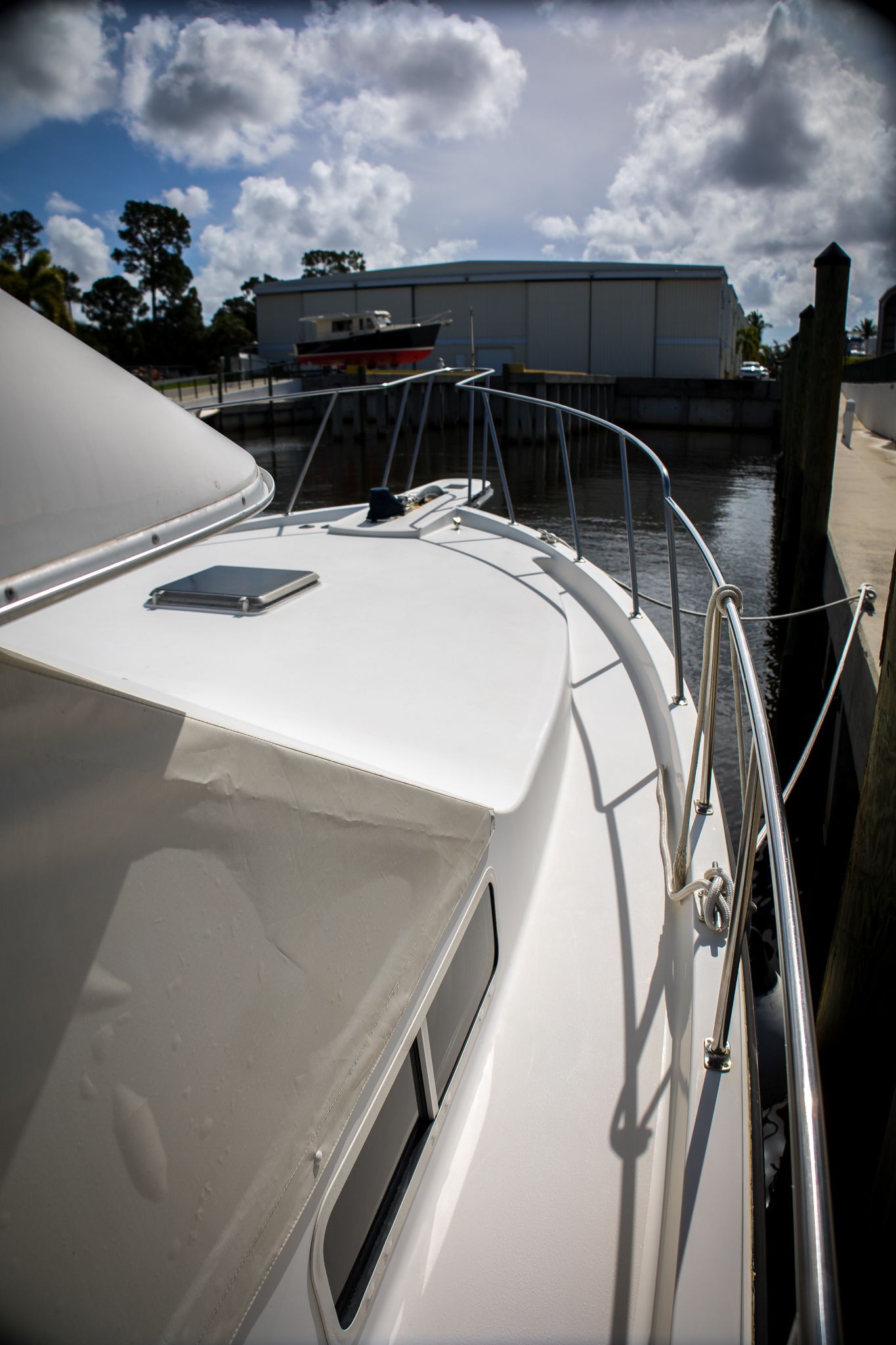 A 1991 Tollycraft 44 Cockpit Motor Yacht docked at a marina.