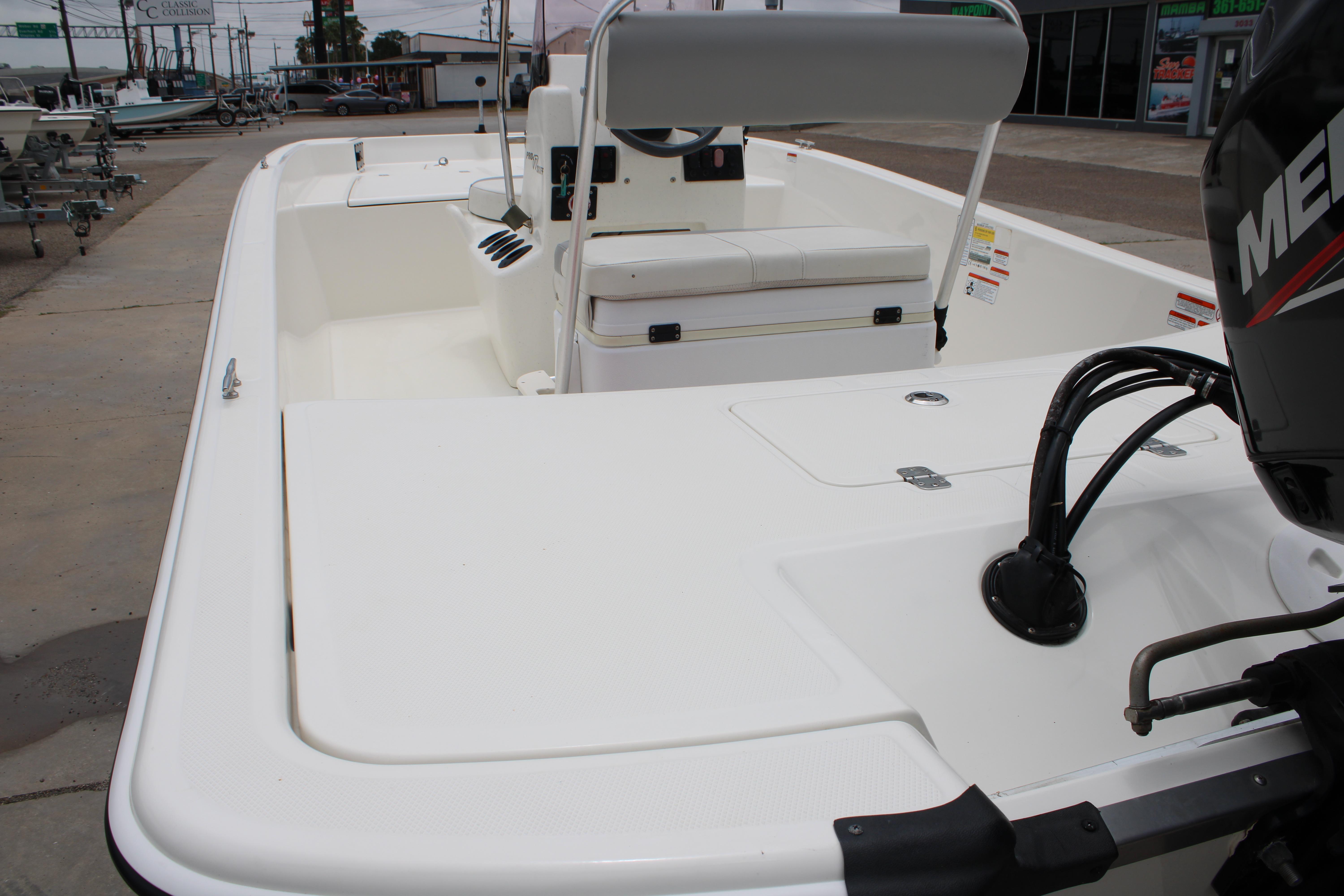 2021 Mako Pro Skiff 17 CC boat with seating and outboard motor, displayed outdoors.