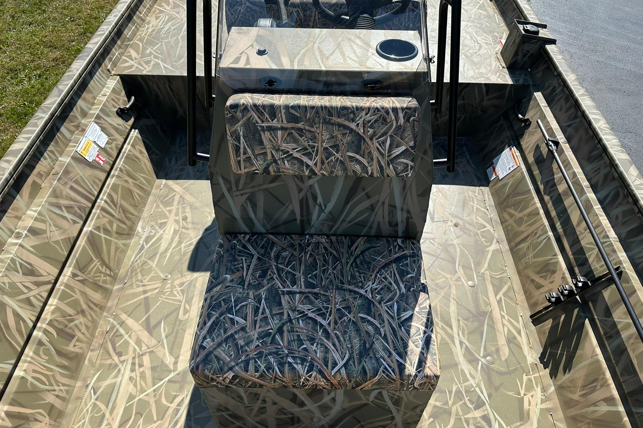 2026 Lowe Roughneck 2070CC boat interior with camouflage seating and console.