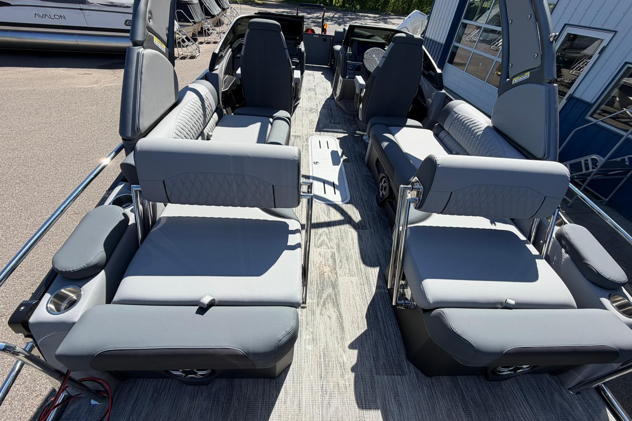 2026 Avalon Excalibur LTD Quad Lounge boat interior with gray seating and windshield.