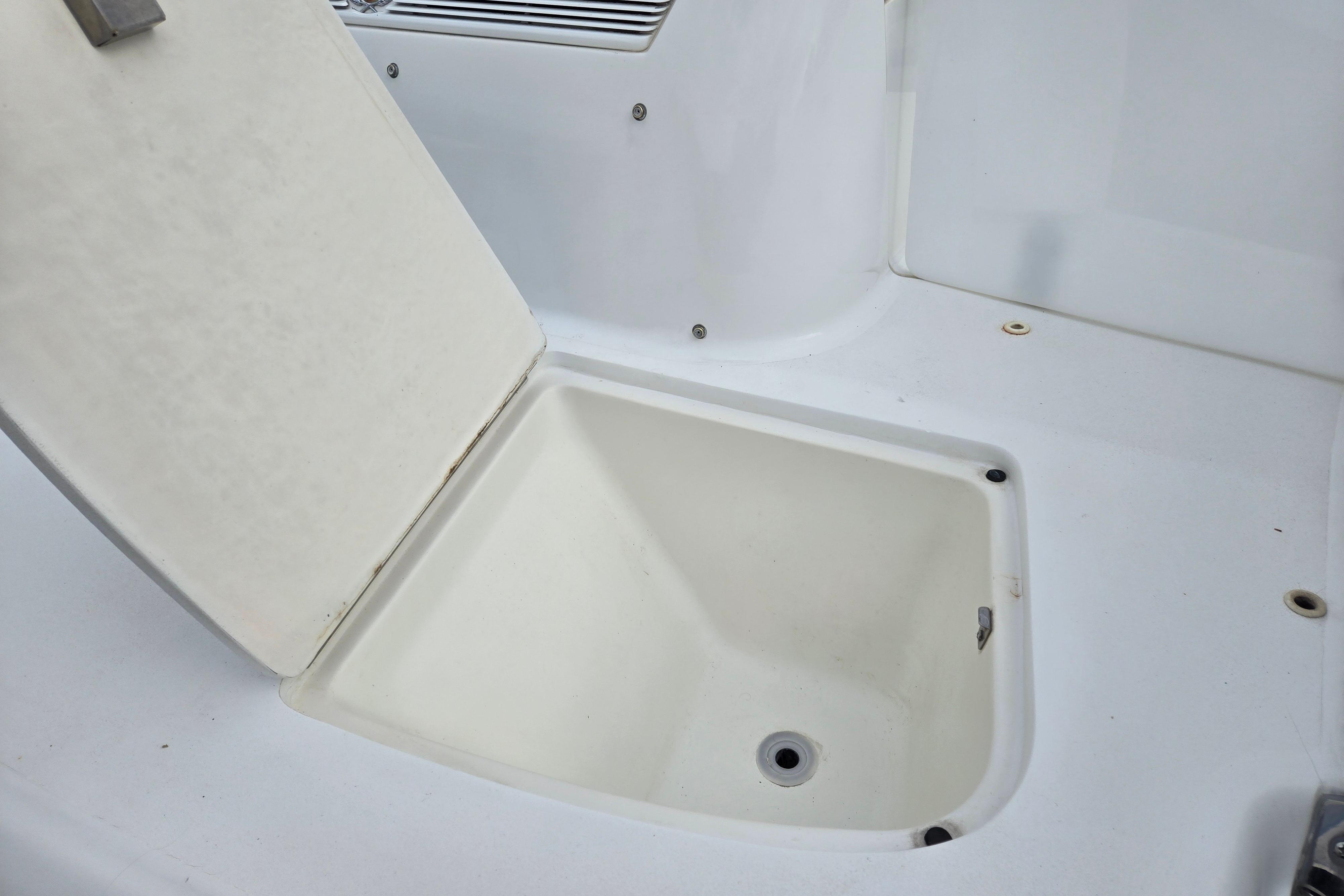 Open storage compartment on a 2000 Cobalt 246 boat, showcasing interior space.