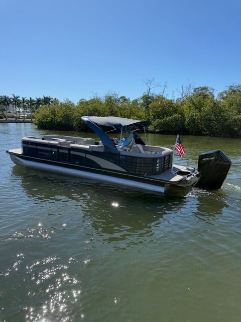 2022 Bennington 28RSRX1 pontoon boat on calm water.