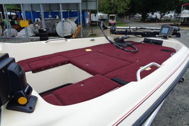 1996 Quantum 180 XD boat with maroon interior, featuring storage compartments and fishing equipment.