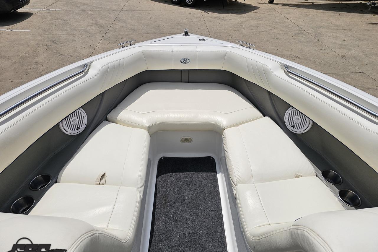 2010 Cobalt 232 WSS boat interior with white leather seating and built-in speakers.