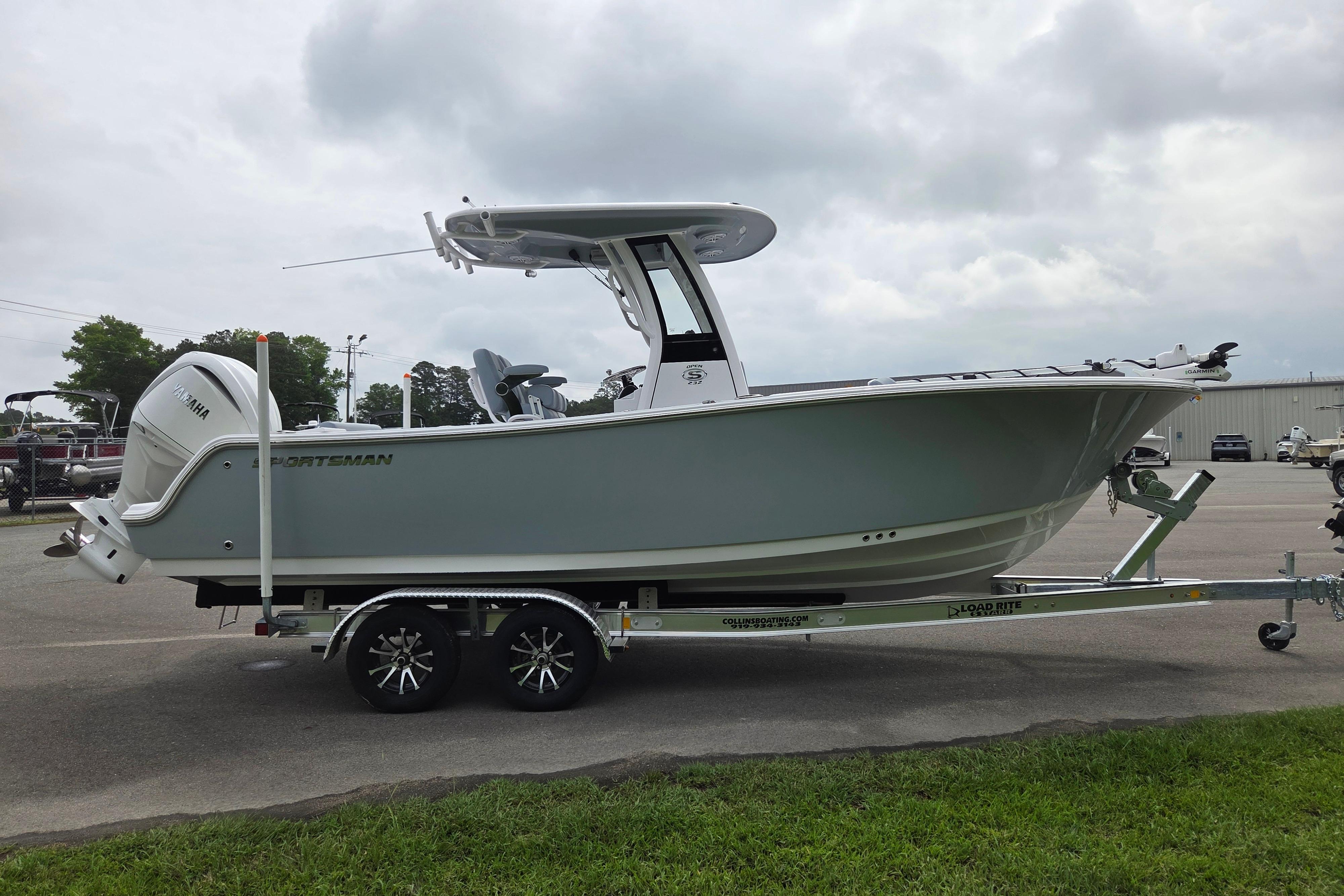 2026 Sportsman Open 232 Center Console boat on trailer, parked outdoors.