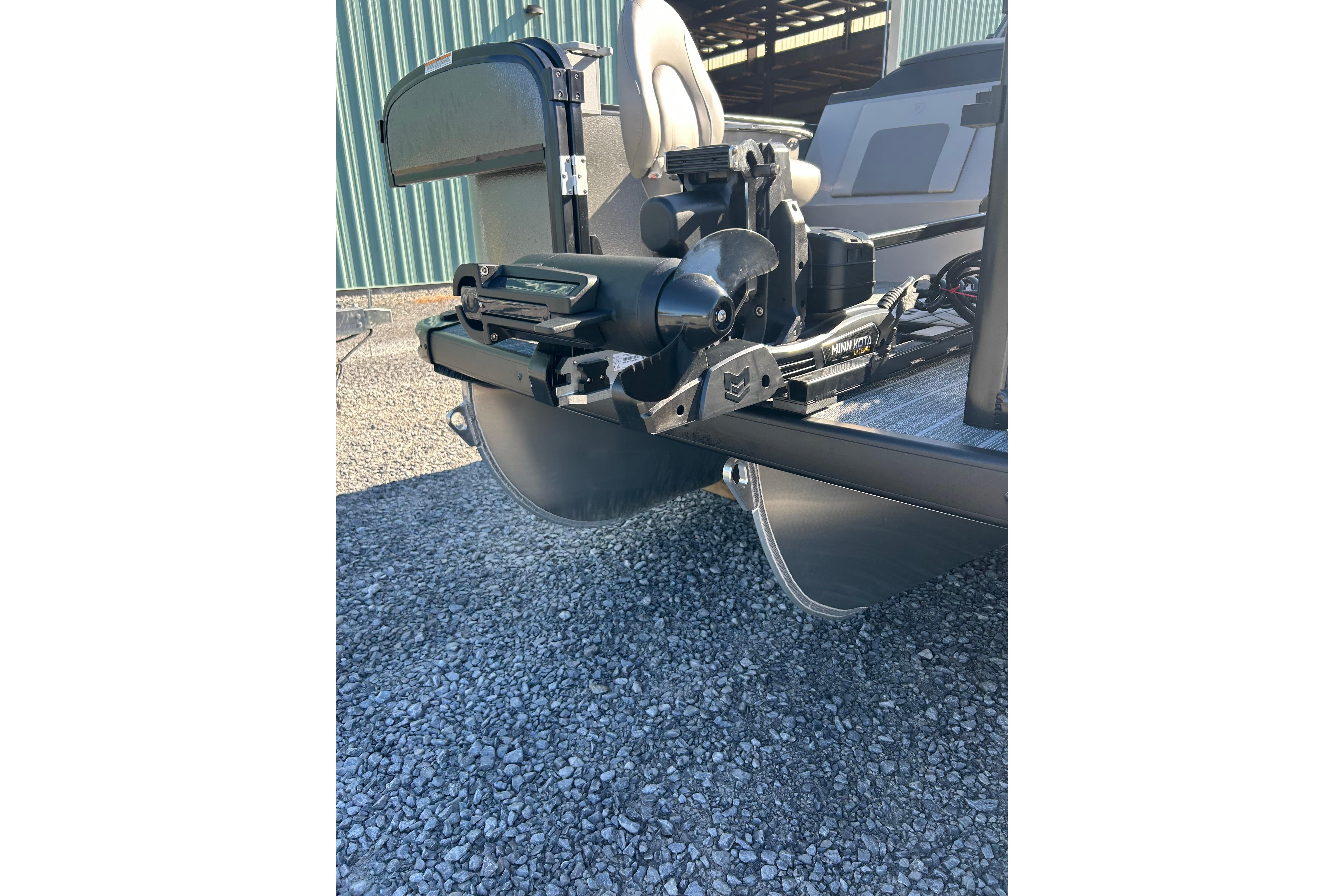 2026 Premier 230 Sunsation Angler 4pt boat with Minn Kota motor, on gravel surface.