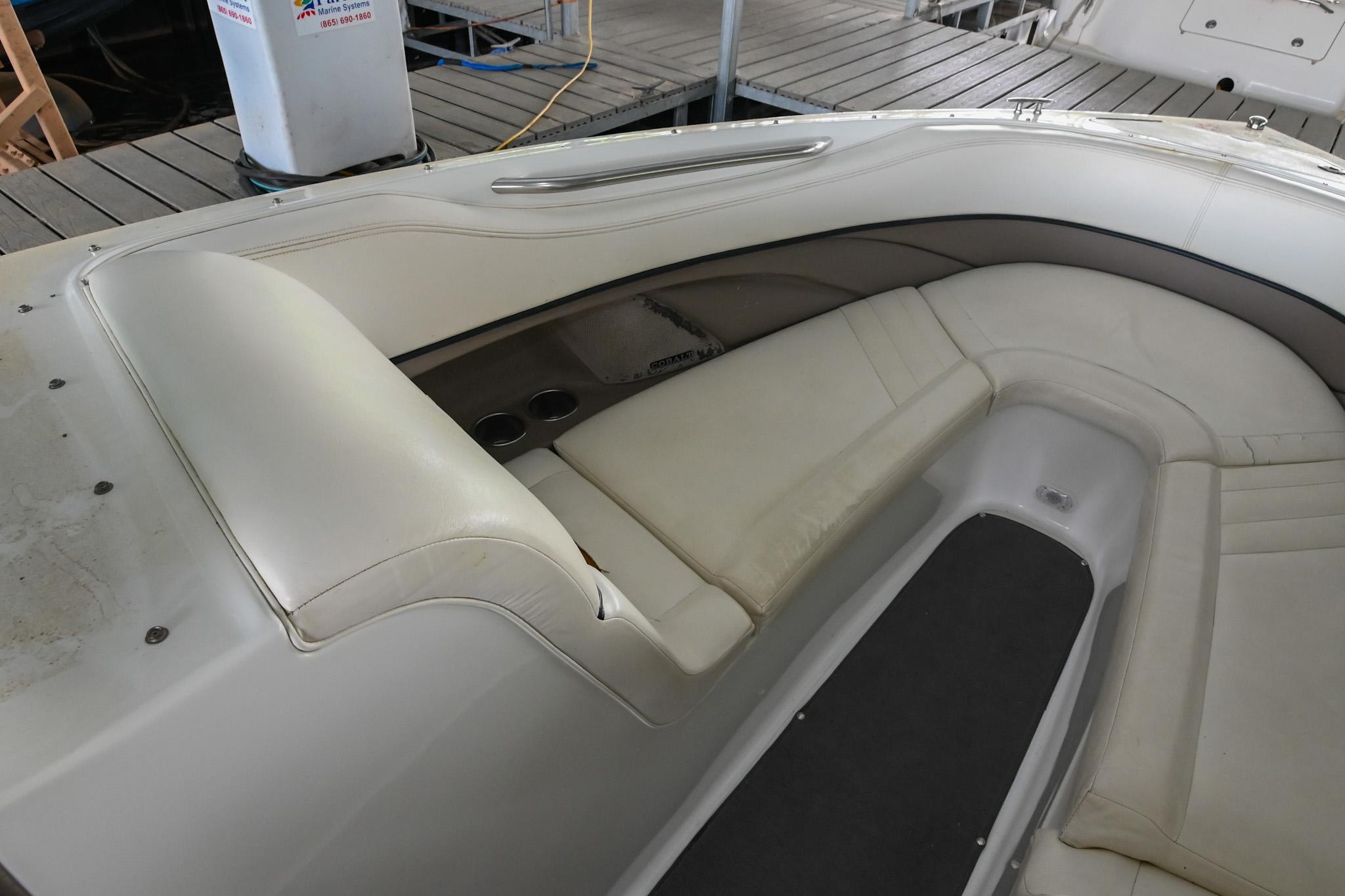 2005 Cobalt 262 boat interior with white leather seating and cup holders.