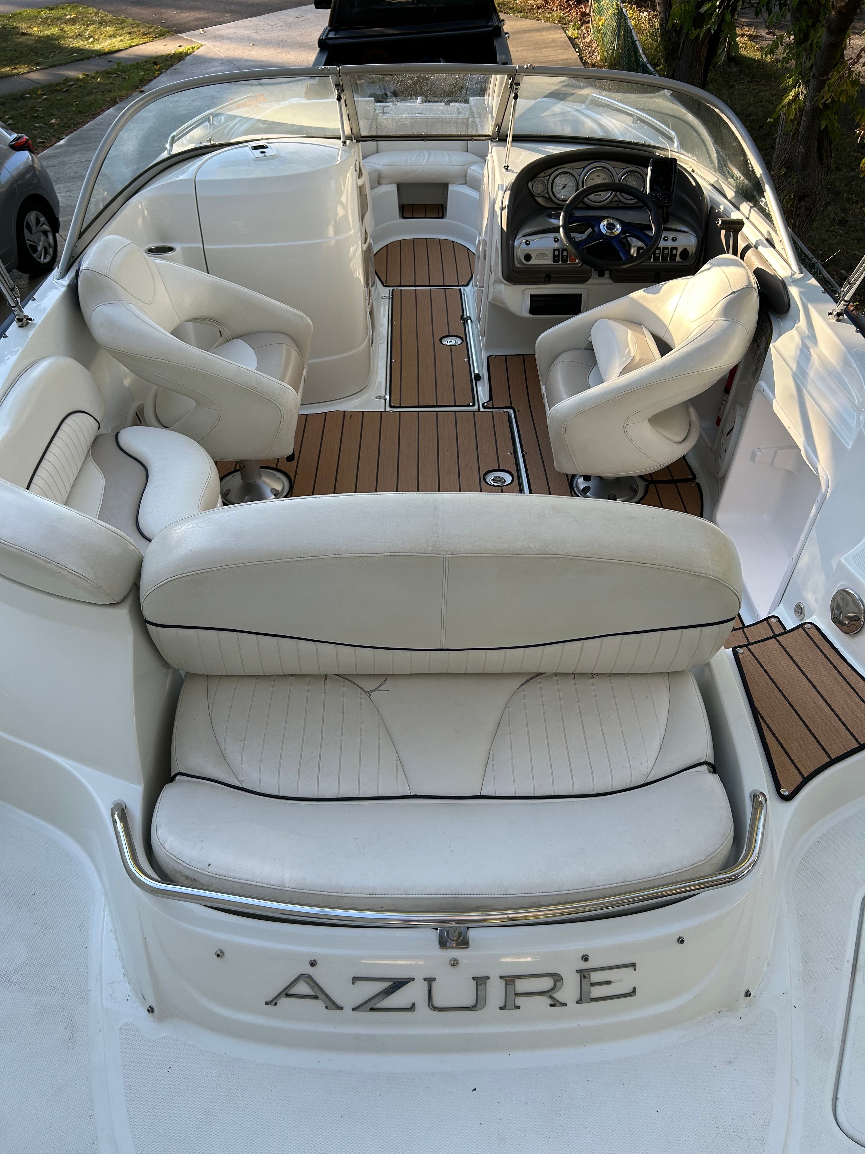 The image shows the cockpit of a 2008 Azure AZ220 boat with white leather seats.