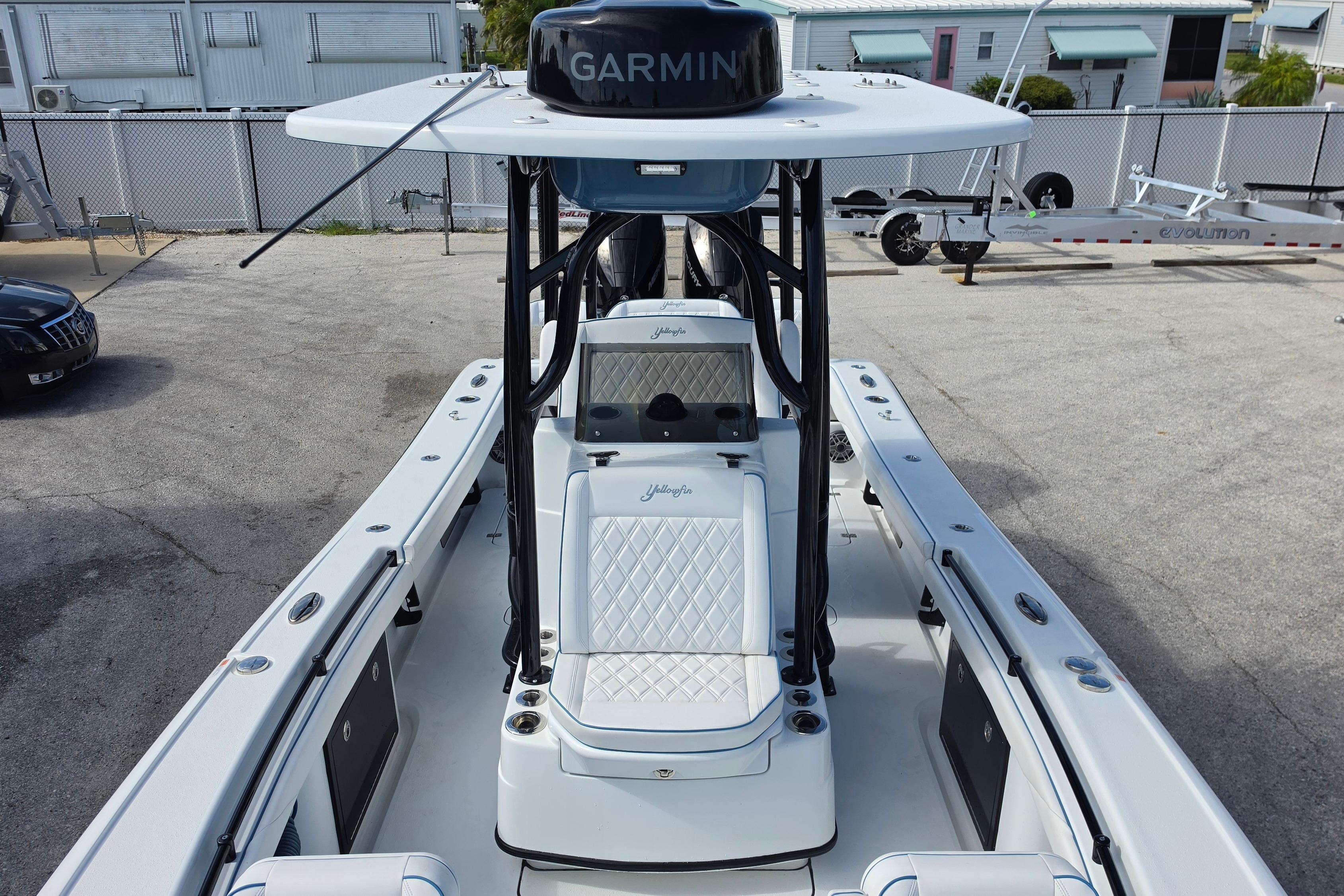 2025 Yellowfin 26 Hybrid boat with Garmin equipment, docked in a marina.