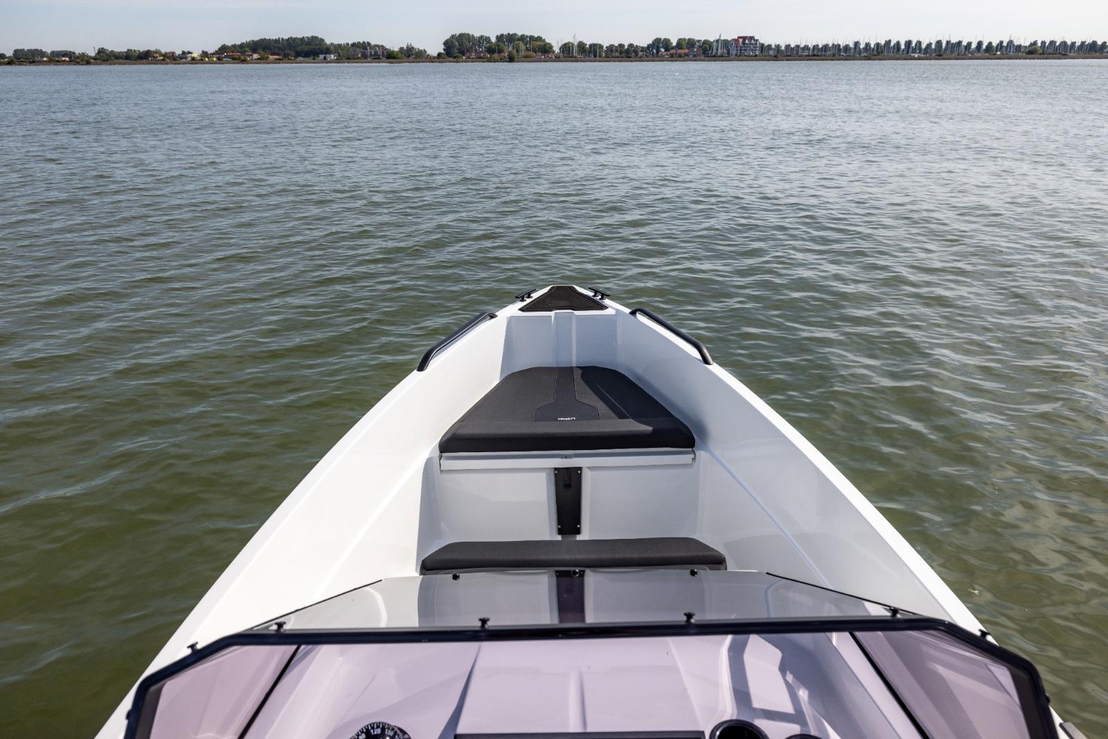 Bow view of 2022 Iron 707 boat on calm water.