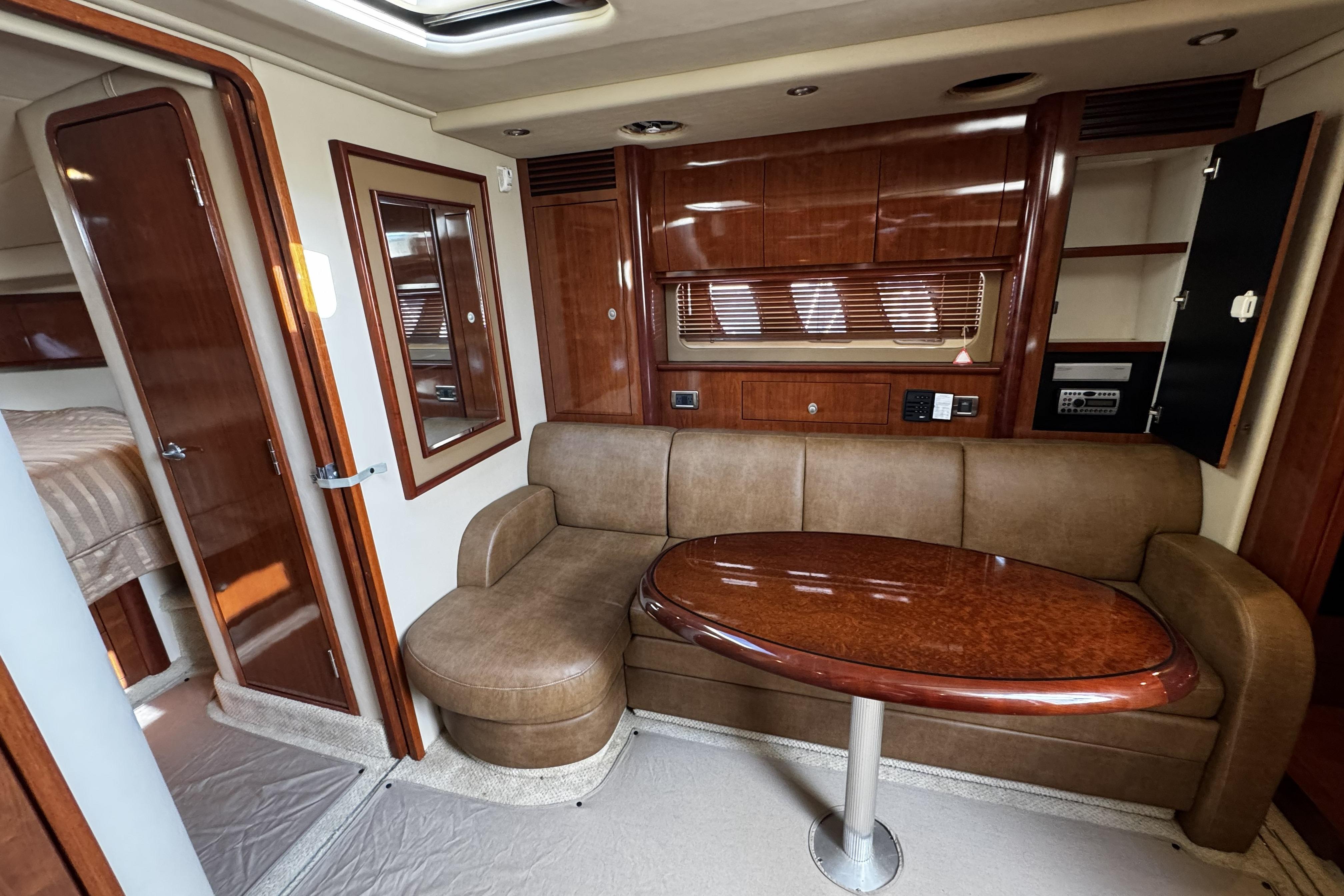 Luxurious interior of 2006 Sea Ray 40 Sundancer yacht with leather seating and wooden finishes.