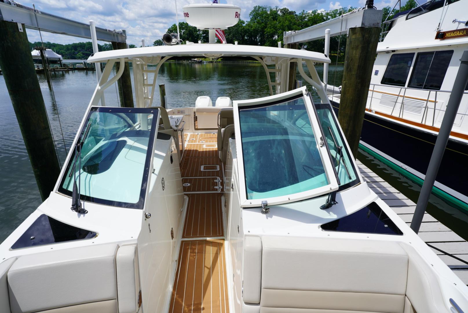 2016 Boston Whaler 320 Vantage docked, showcasing open cockpit and seating area.