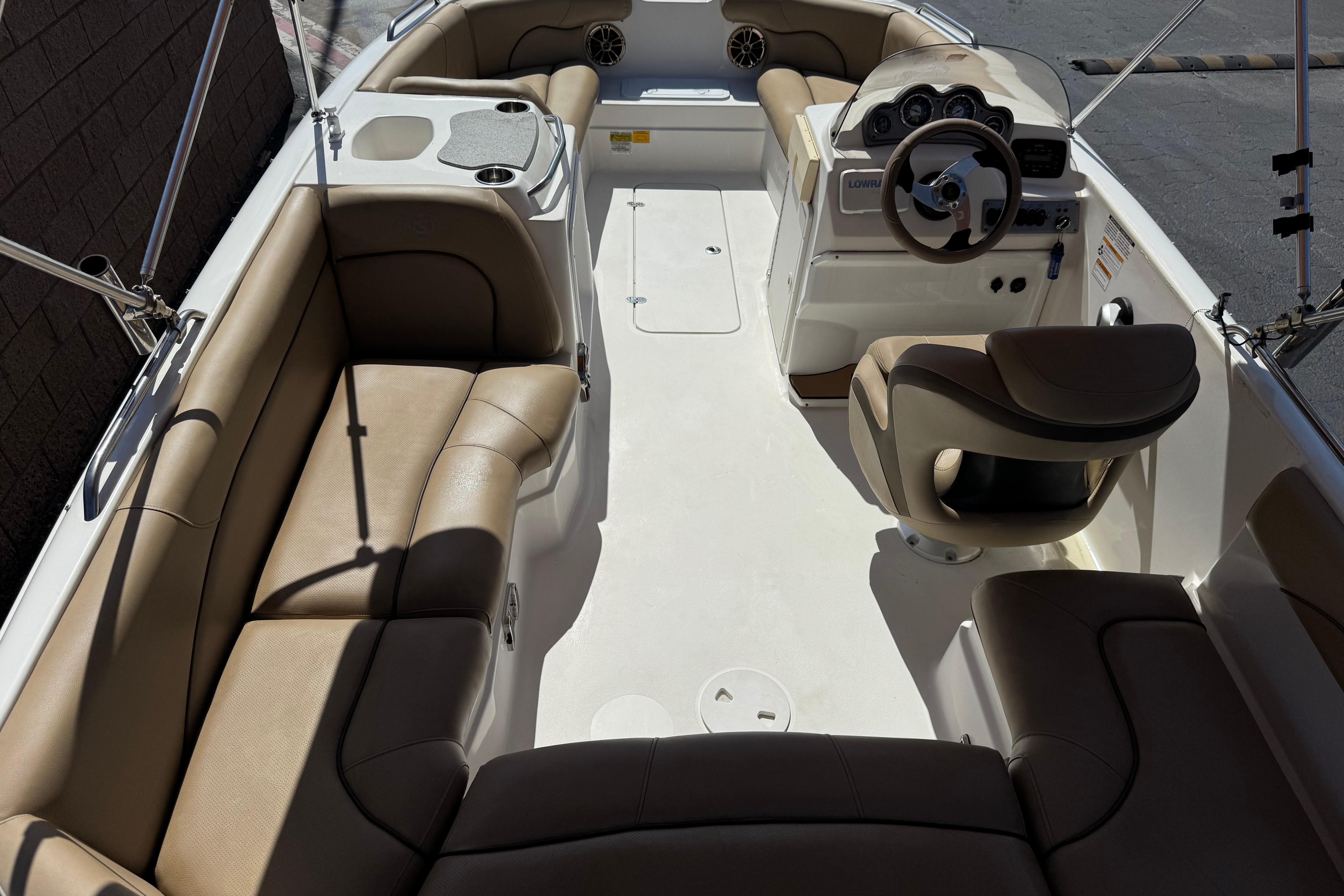 2020 NauticStar 203 SC boat interior with tan seating and steering console.