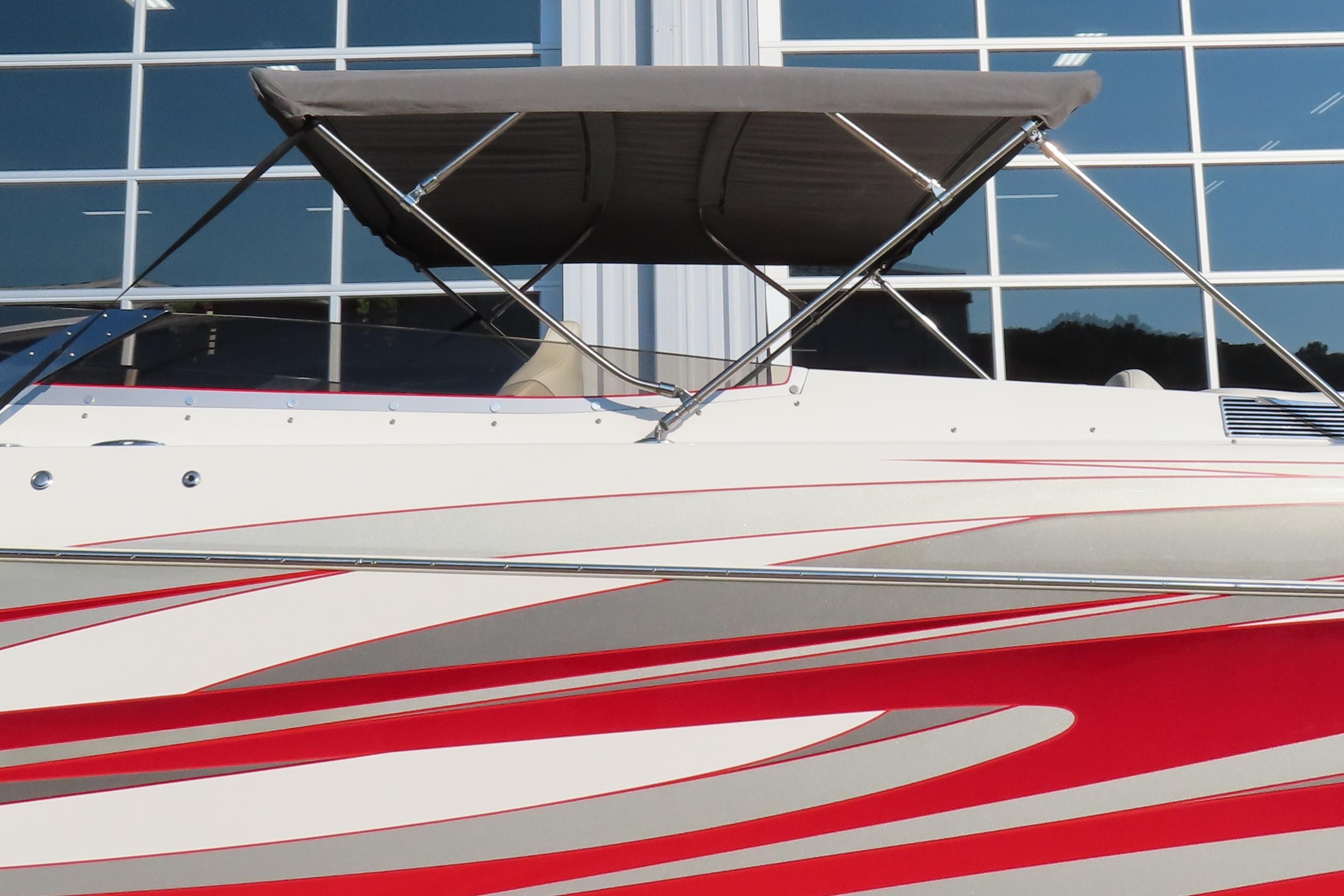 2013 Nordic 39 POKER RUN boat with red and white design, parked near glass windows.
