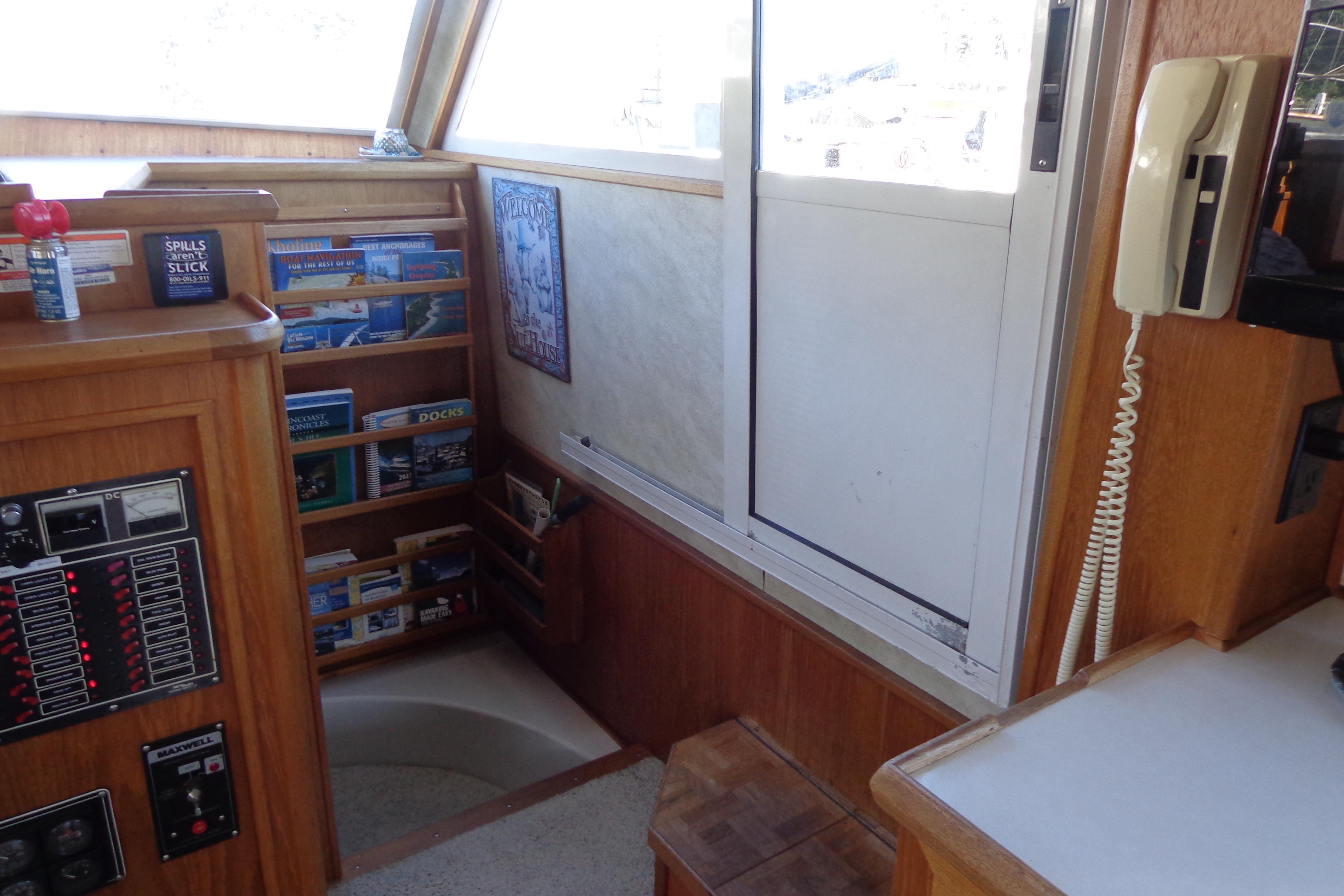 Interior of 1992 Cruise-A-Home Corsair 4200 with control panel and bookshelf.