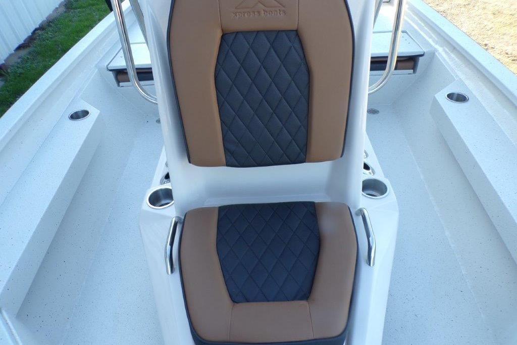 2026 Xpress H20B Bay boat interior with brown and black cushioned seating.