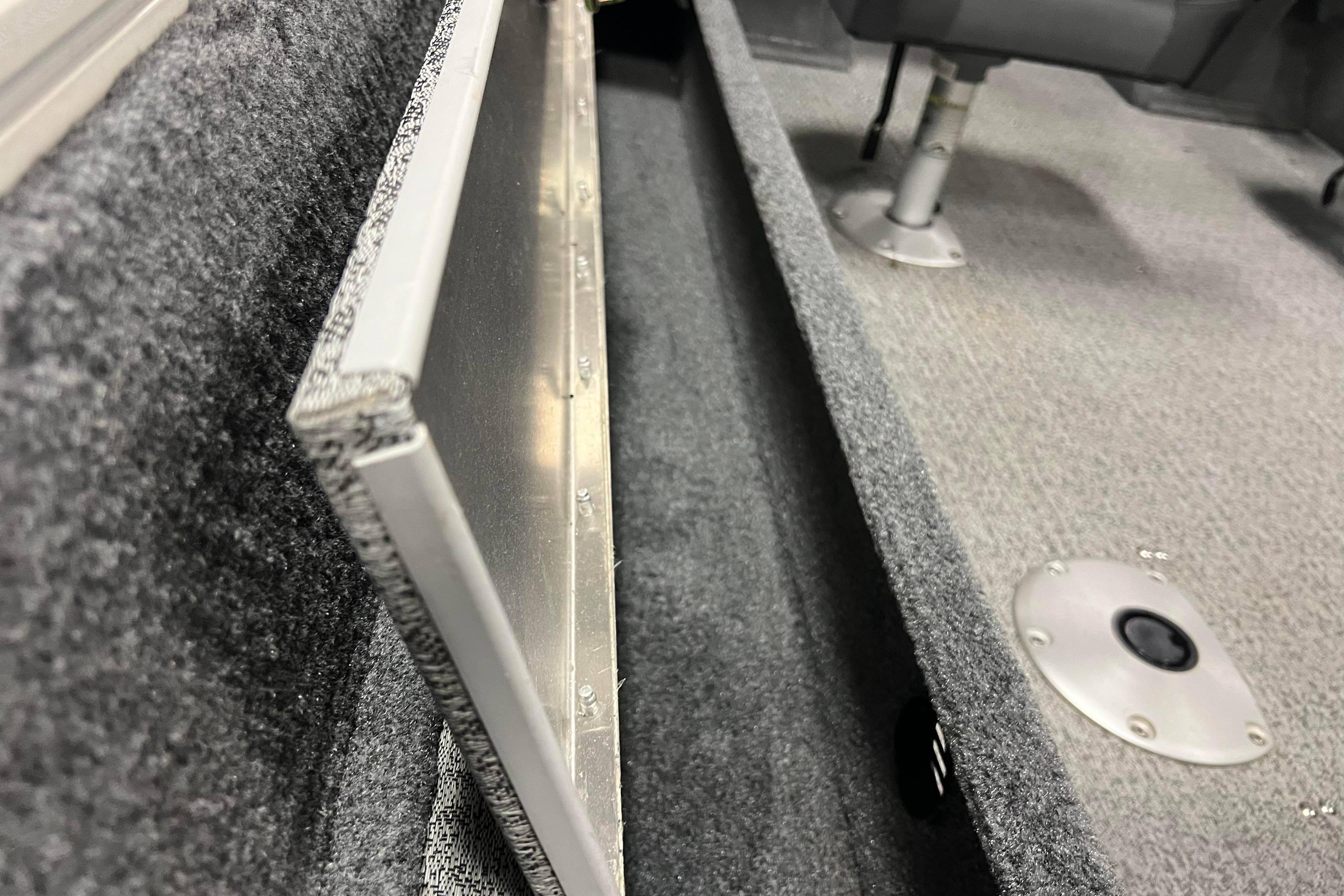 2022 Tracker Pro Guide V-16 WT interior, featuring carpeted storage and seating area.