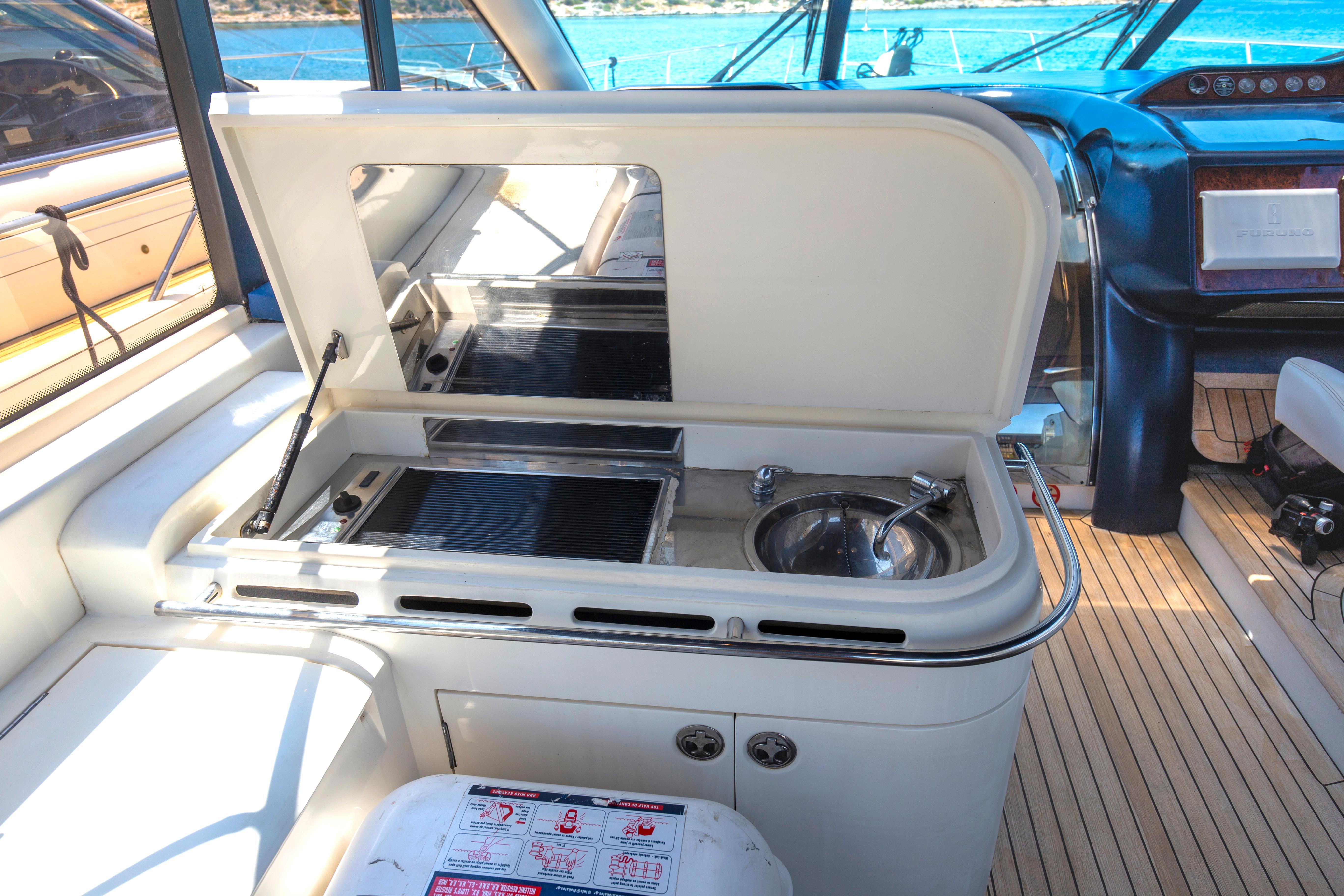 Luxury yacht Princess V65 interior with kitchenette and sink, 2004 model.