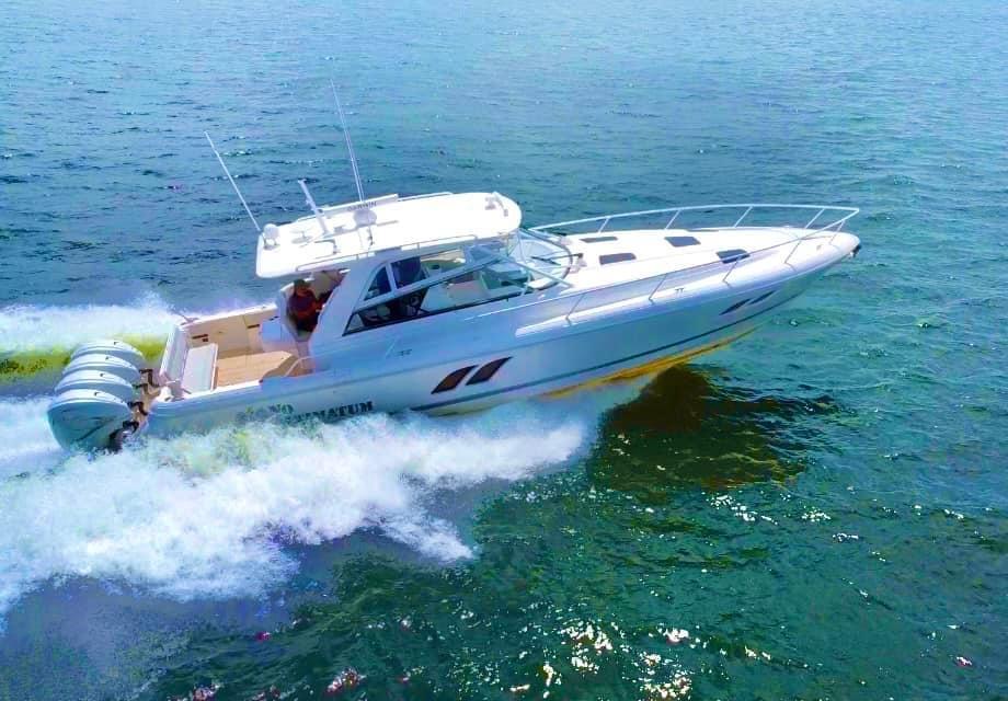 2020 Intrepid 475 Sport Yacht cruising on open water, showcasing sleek design and powerful engines.
