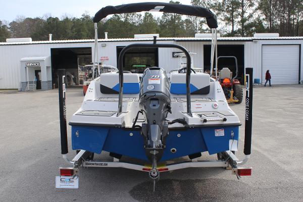 2025 Starcraft SV 16 OB boat on trailer, rear view, parked outside service center.
