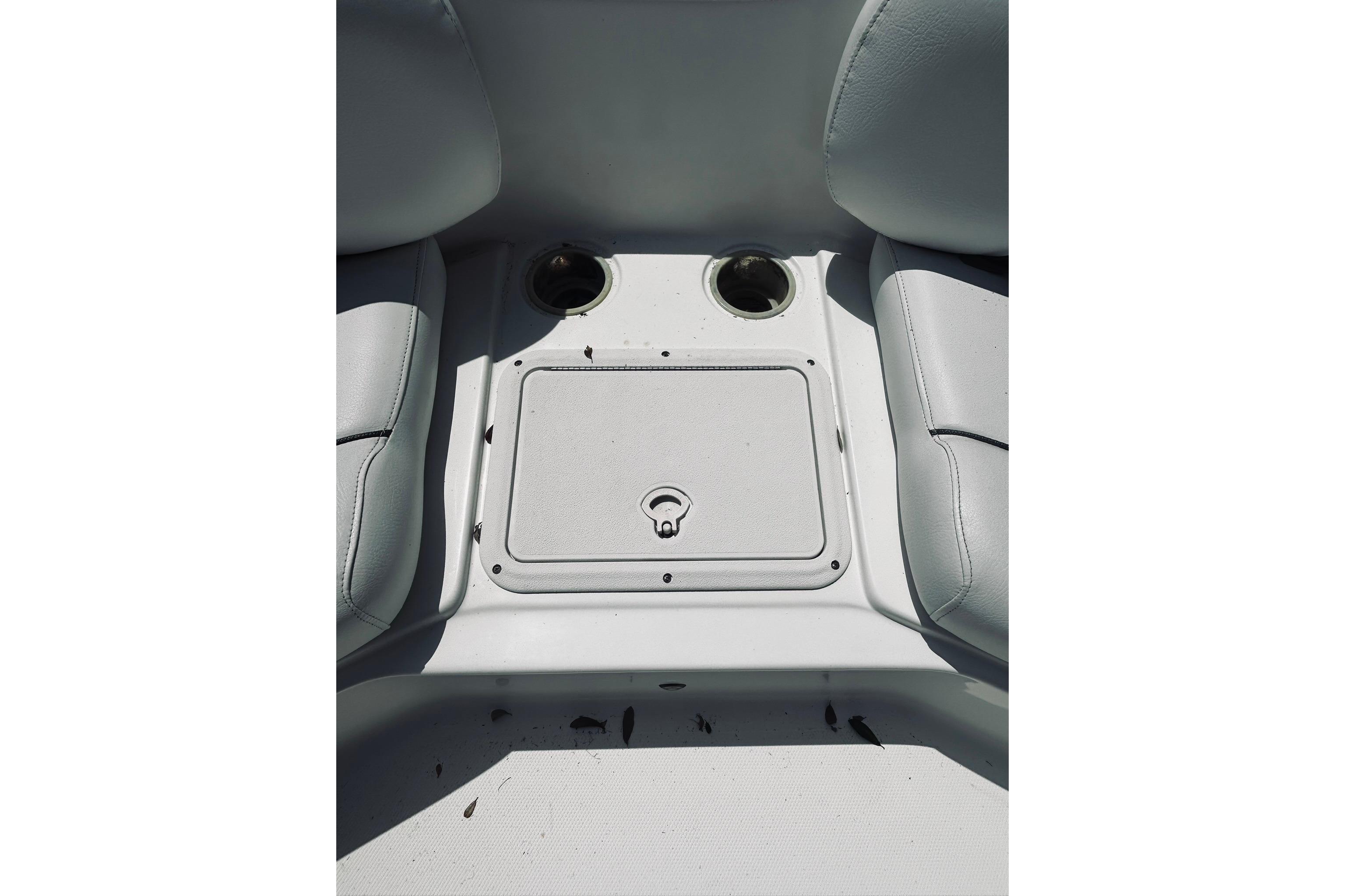 2013 Hurricane SunDeck Sport 201 OB boat interior with cup holders and storage compartment.
