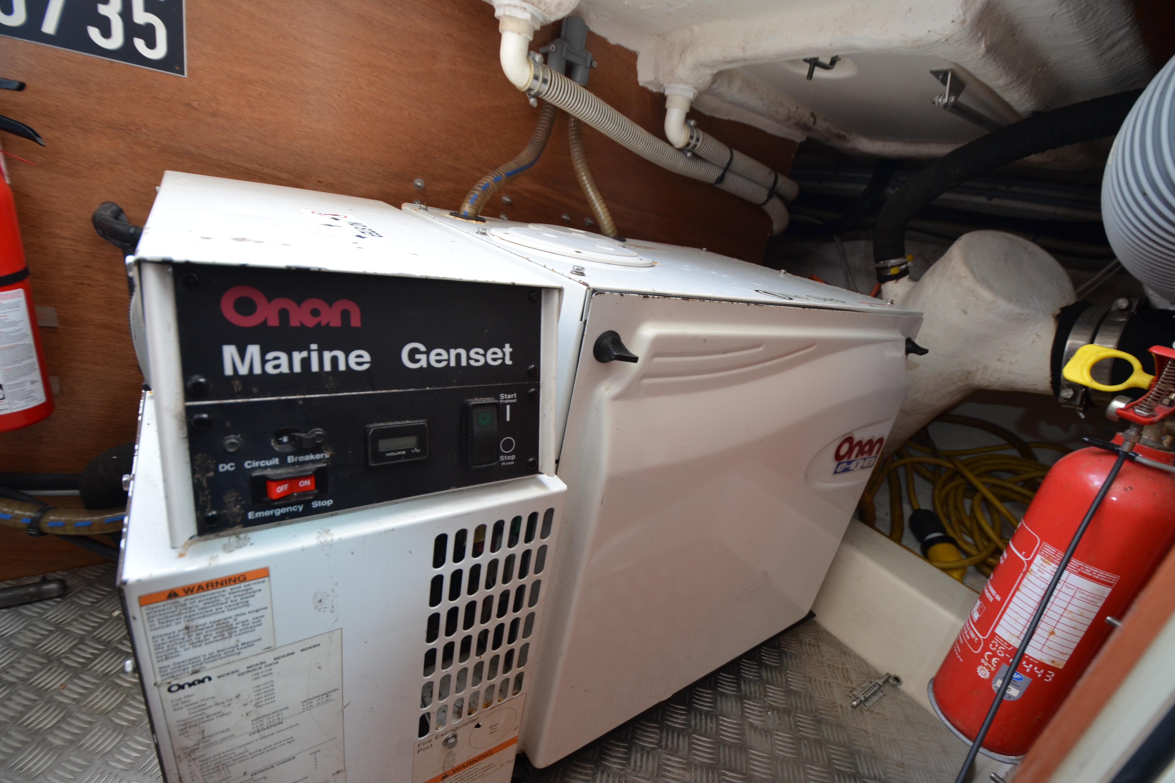 Onan Marine Genset in 2007 Jeanneau Prestige 46 engine room with fire extinguisher.