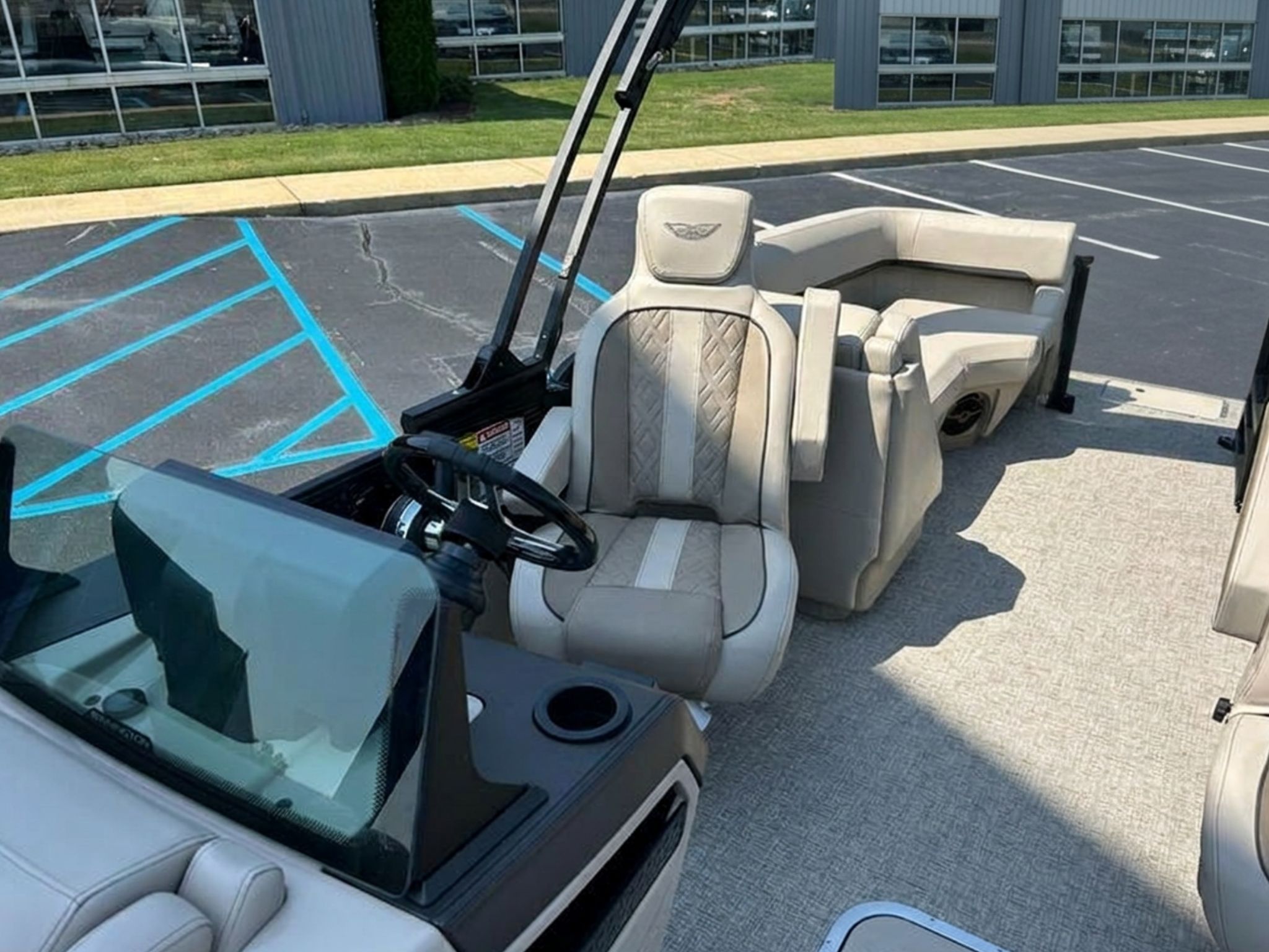 The image shows the interior of a 2026 Bennington 22 MFB with beige seating and a steering wheel.