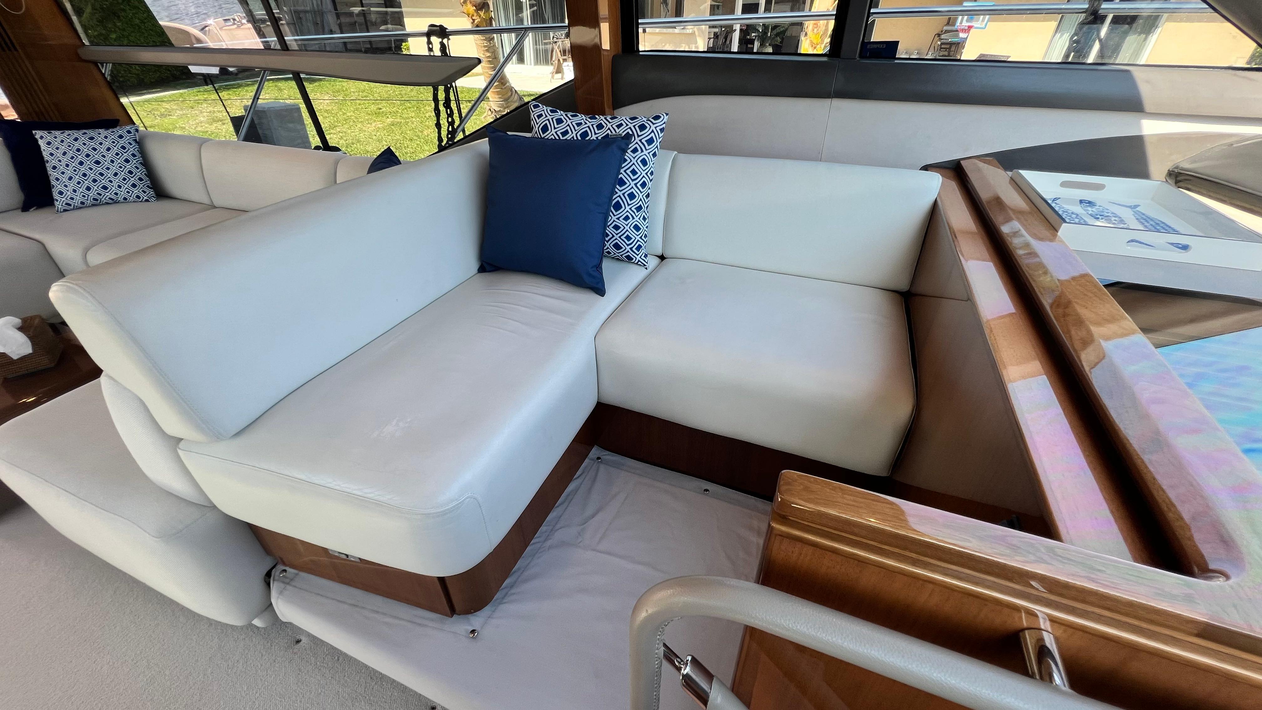 Luxurious interior seating on a 2019 Princess F62 yacht with elegant cushions.