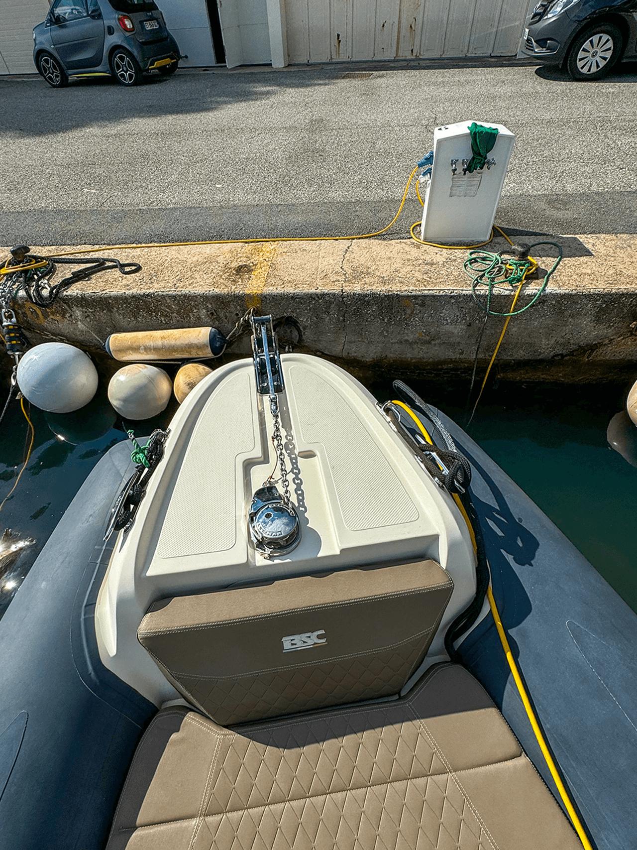 BSC 78 boat docked at marina, 2019 model, with visible anchor and seating.