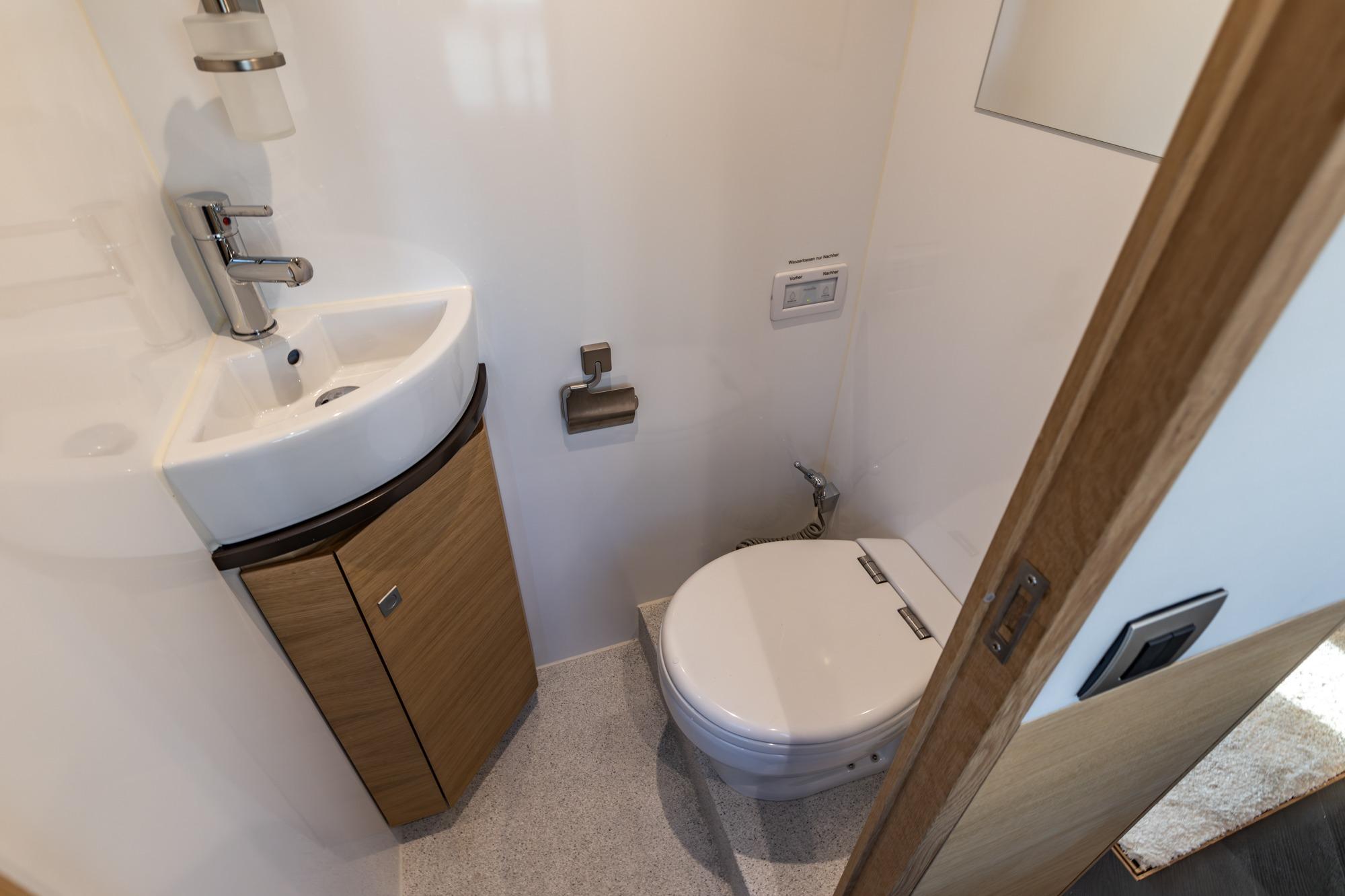 Compact bathroom in 2017 Steeler Panorama FF 53 yacht with sink and toilet.