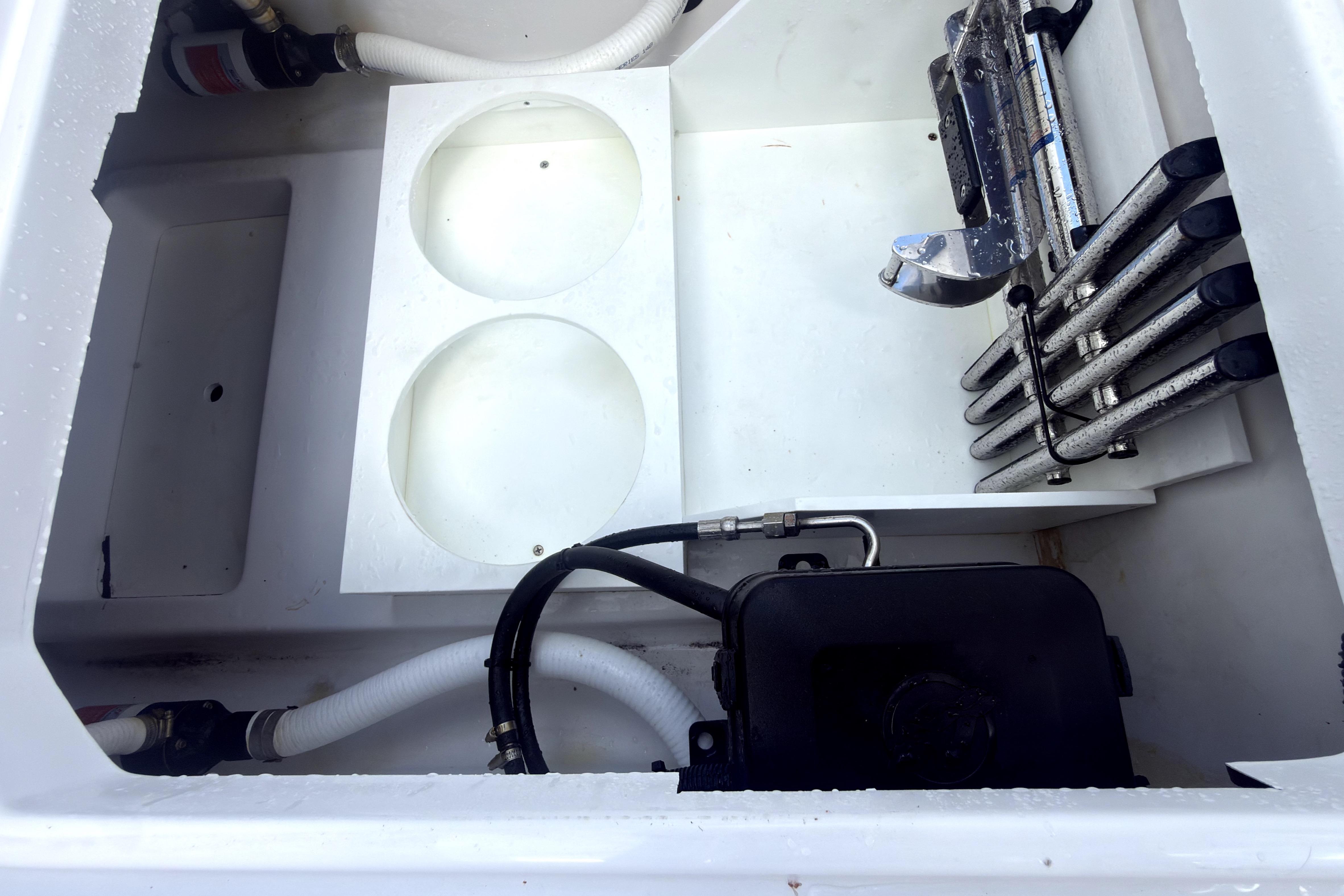 Interior view of 2023 Bertram 28 CC boat compartment with hoses and equipment.